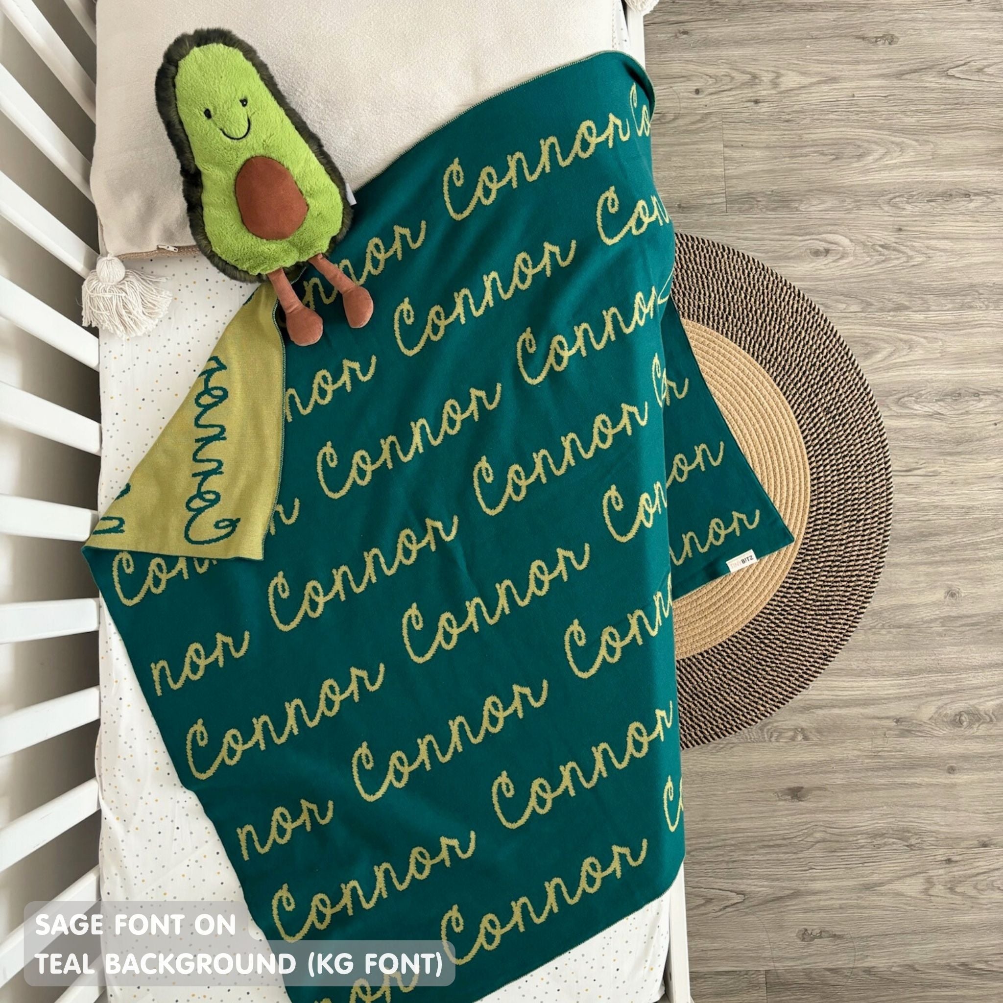 Cotton Kids Blanket with name knitted in teal and sage, made by TinyBitz.