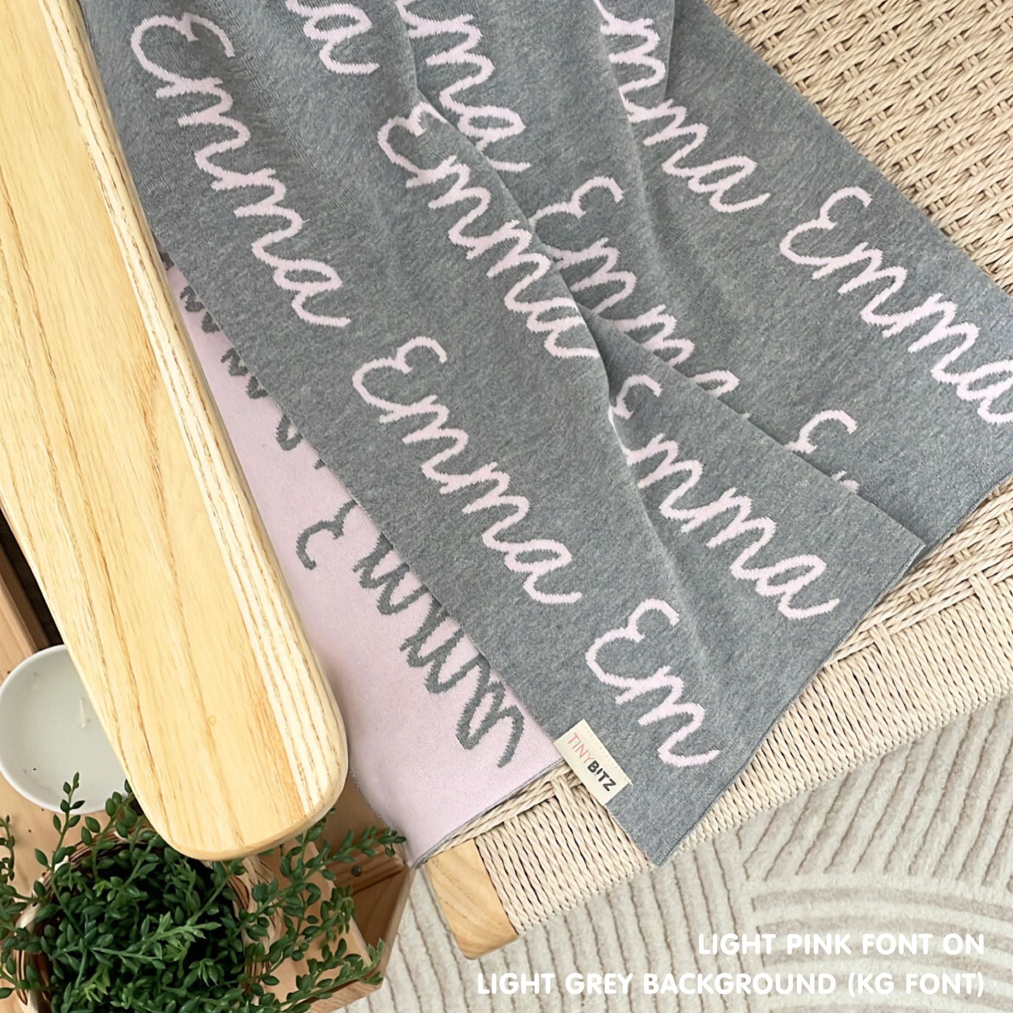 TinyBitz knitted cotton blanket in light grey and pink, personalized with your kid’s name.