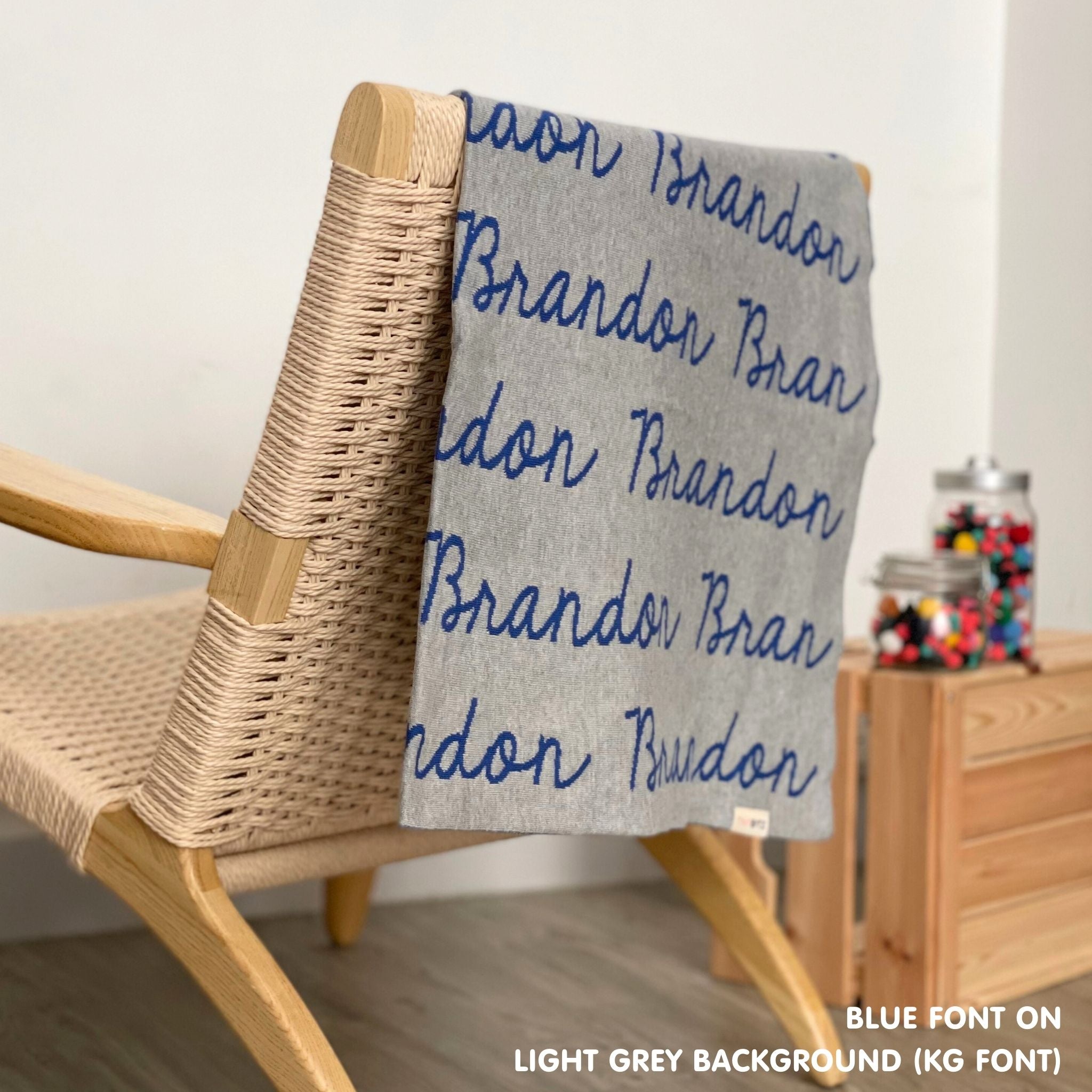 Cotton Kids Blanket with name knitted in light grey and blue, made by TinyBitz.