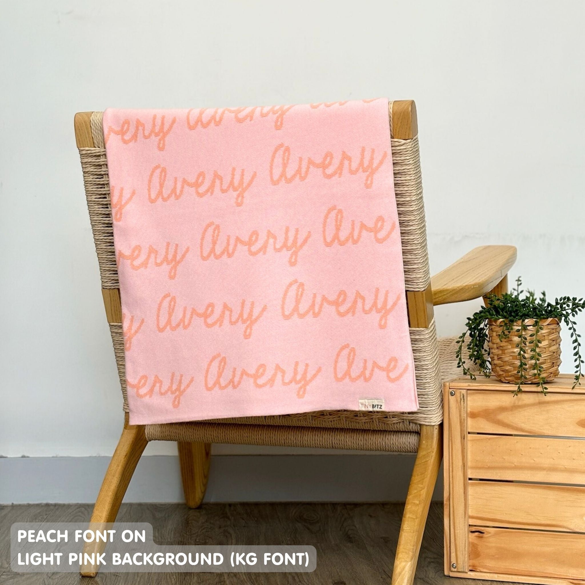 TinyBitz knitted cotton blanket in light pink and peach, personalized with your kid’s name.