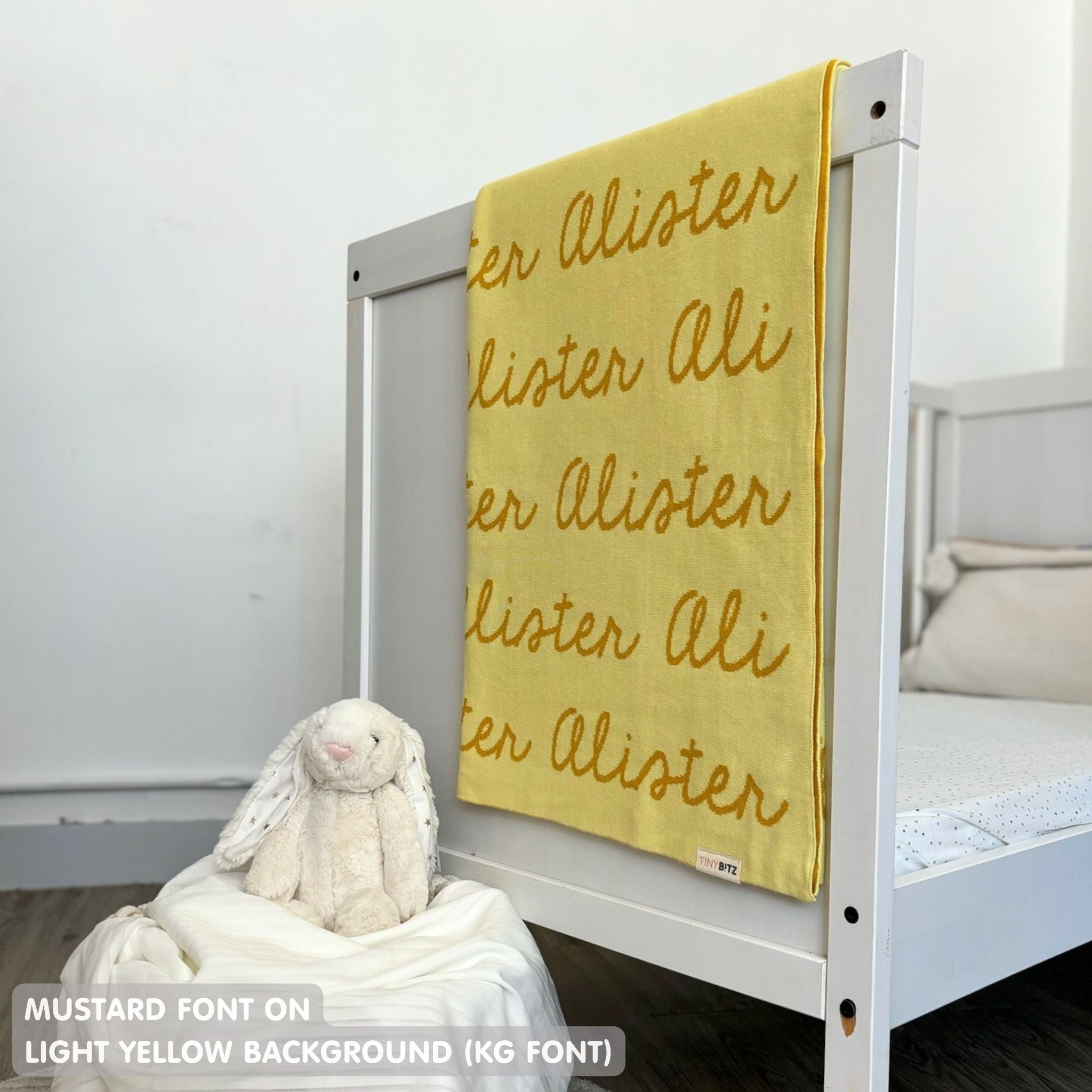 TinyBitz knitted cotton blanket in light yellow and mustard, personalized with your kid’s name.