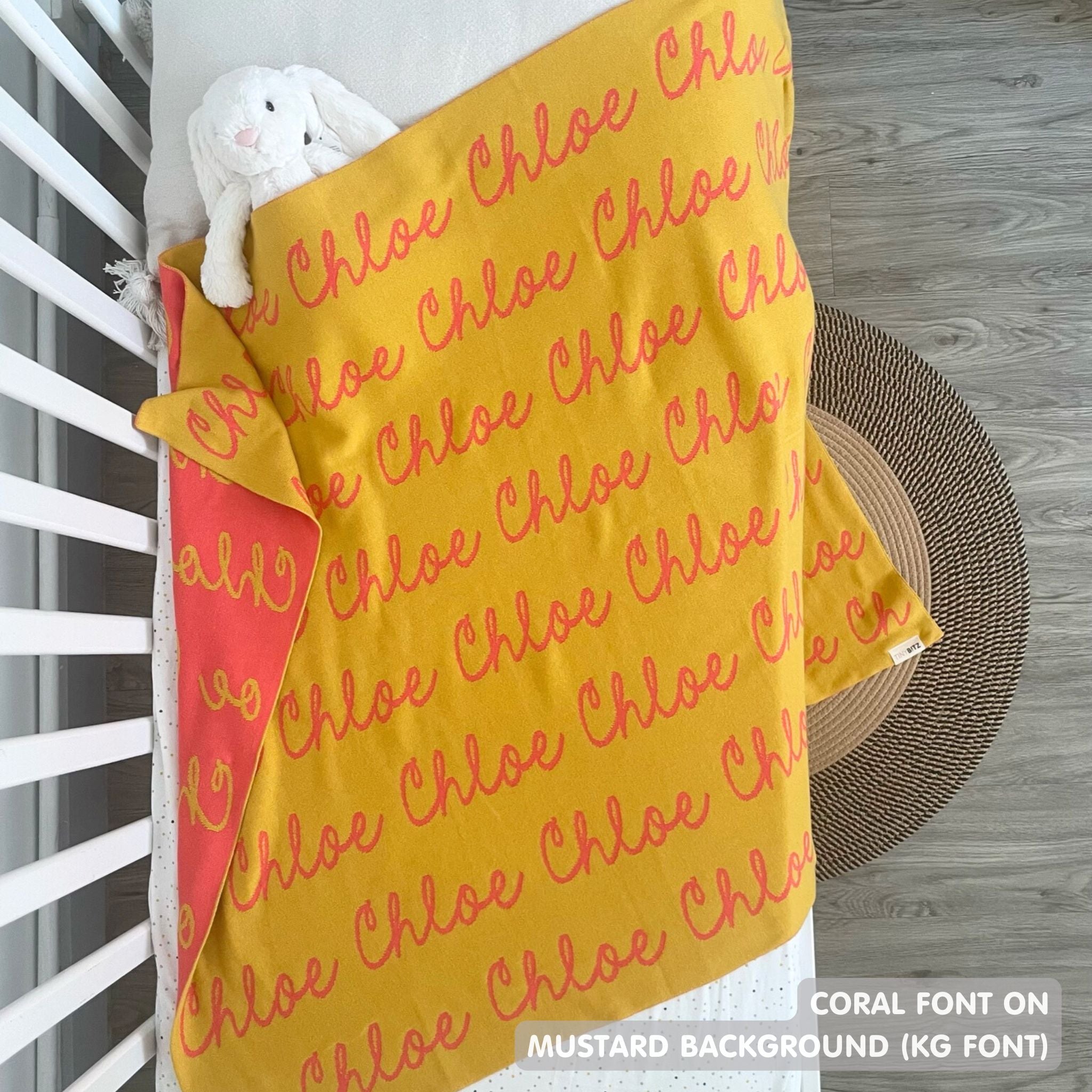 Cotton Kids Blanket with name knitted in mustard and coral, made by TinyBitz.