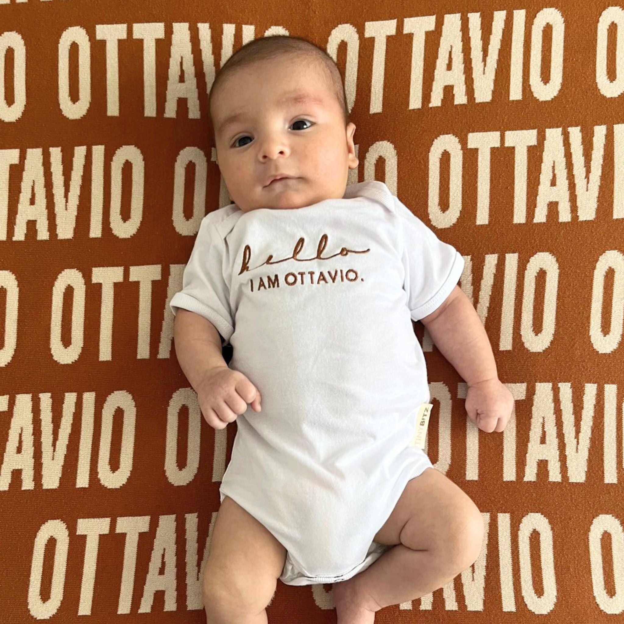 TinyBitz Kids Blanket in rust and oatmeal, personalized with child's name and made from 100% cotton.