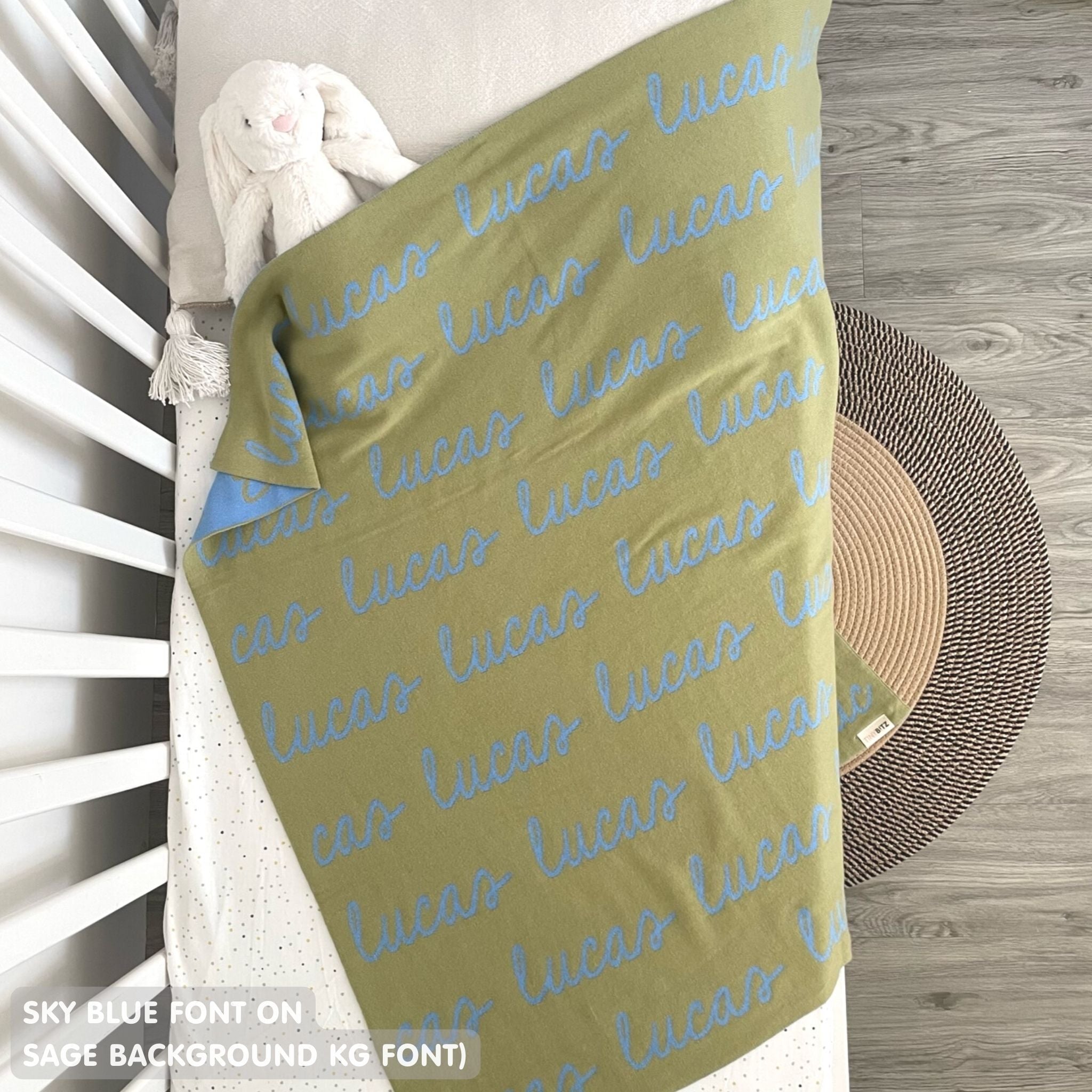 Cotton Kids Blanket with name knitted in sage and sky blue, made by TinyBitz.