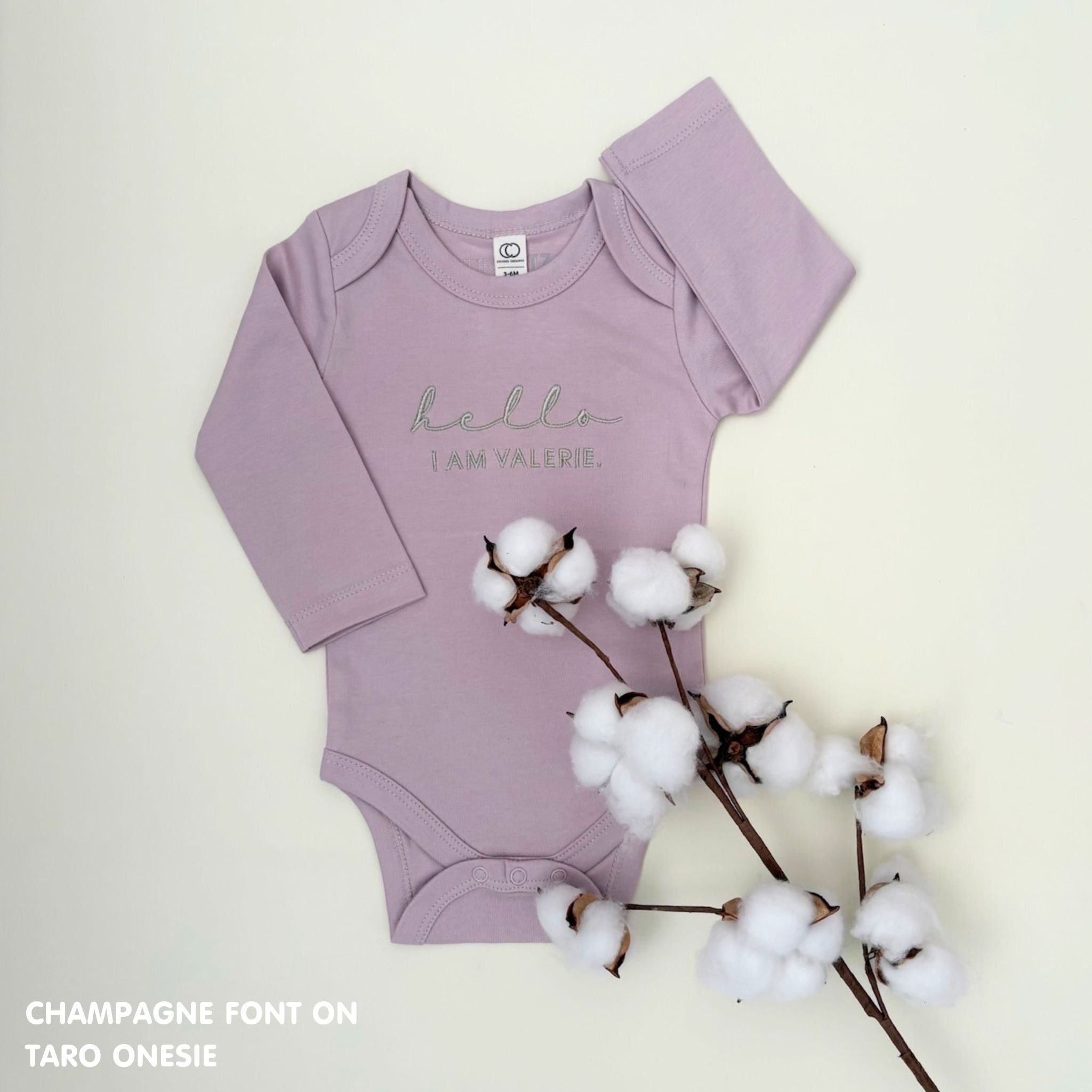Organic cotton baby onesie with custom name, ideal for birth announcements, baby shower gifts, and keepsakes by TinyBitz.