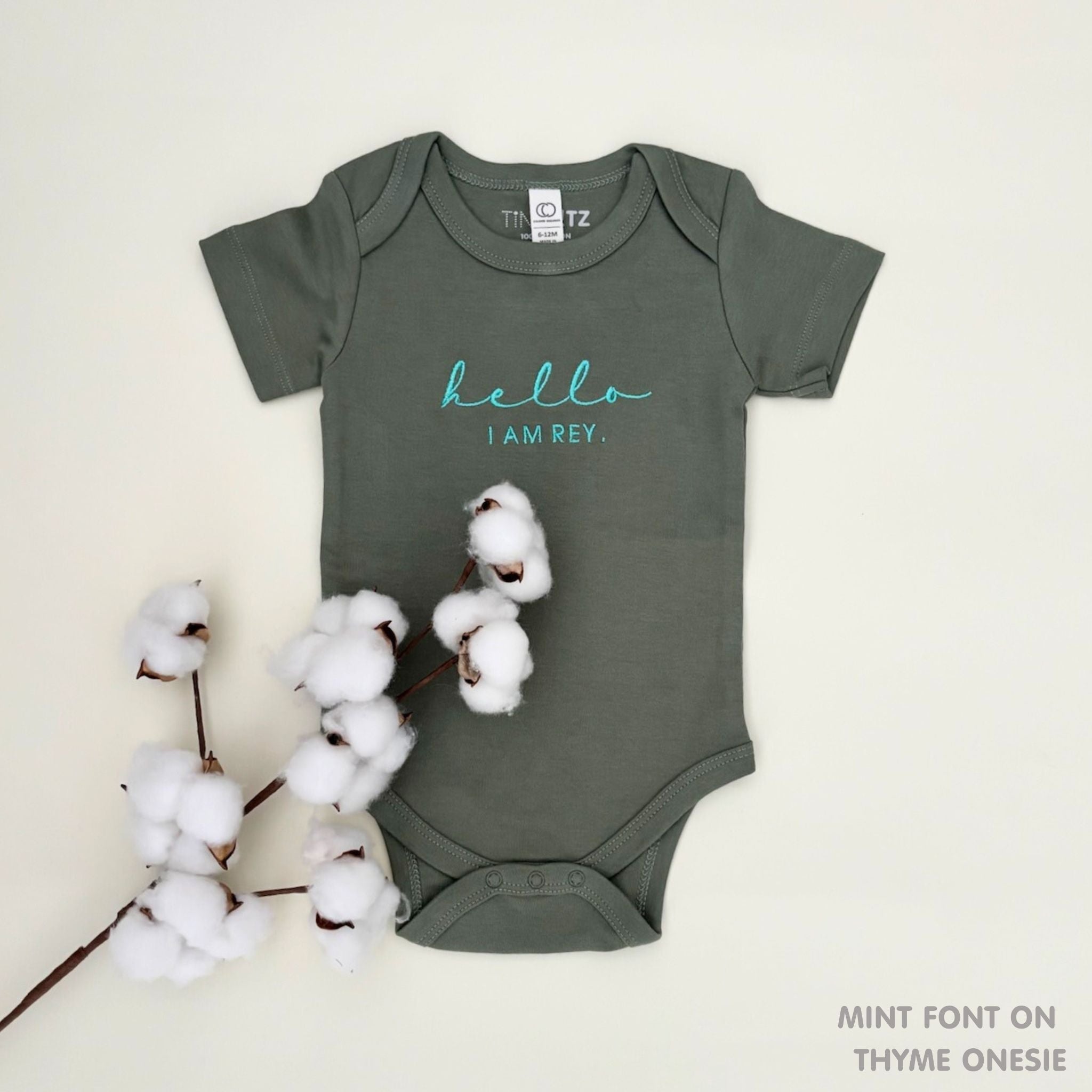 Organic cotton thyme onesie for babies with embroidered name, personalized baby shower gift keepsake from TinyBitz.