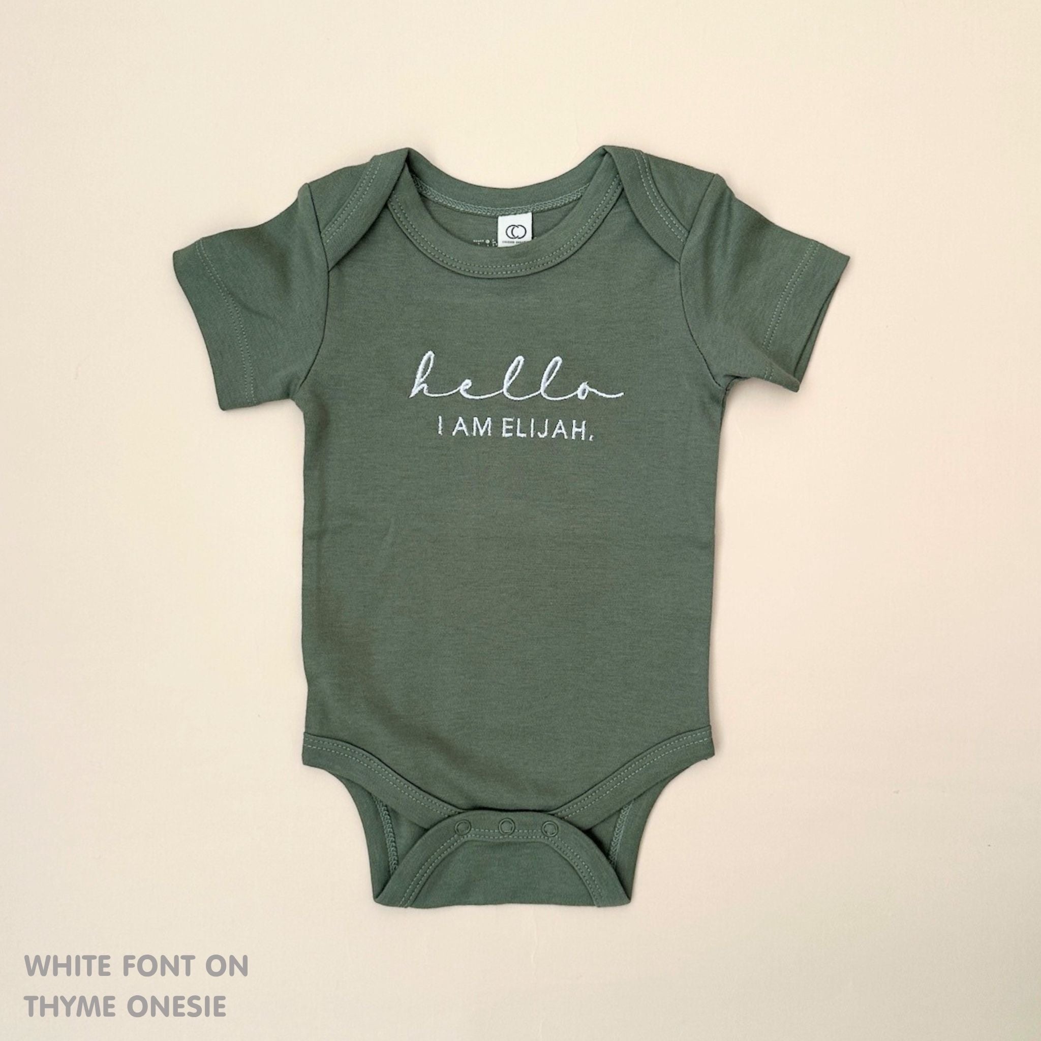 TinyBitz Personalised baby onesie with embroidered name in soft thyme cotton, perfect for birth announcements and newborn photos.