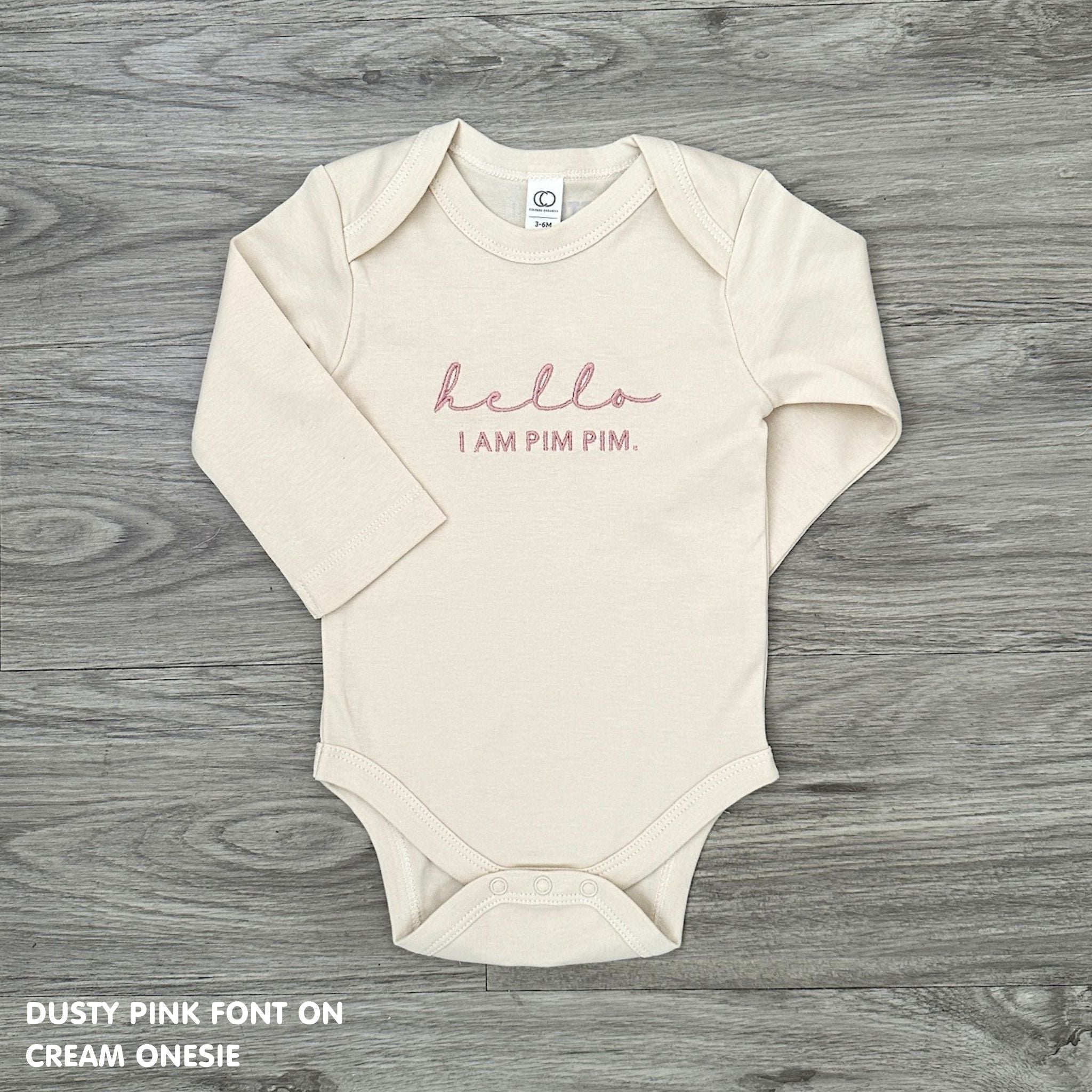 Neutral-tone personalised baby onesie featuring custom name, made-to-order newborn gift by TinyBitz.