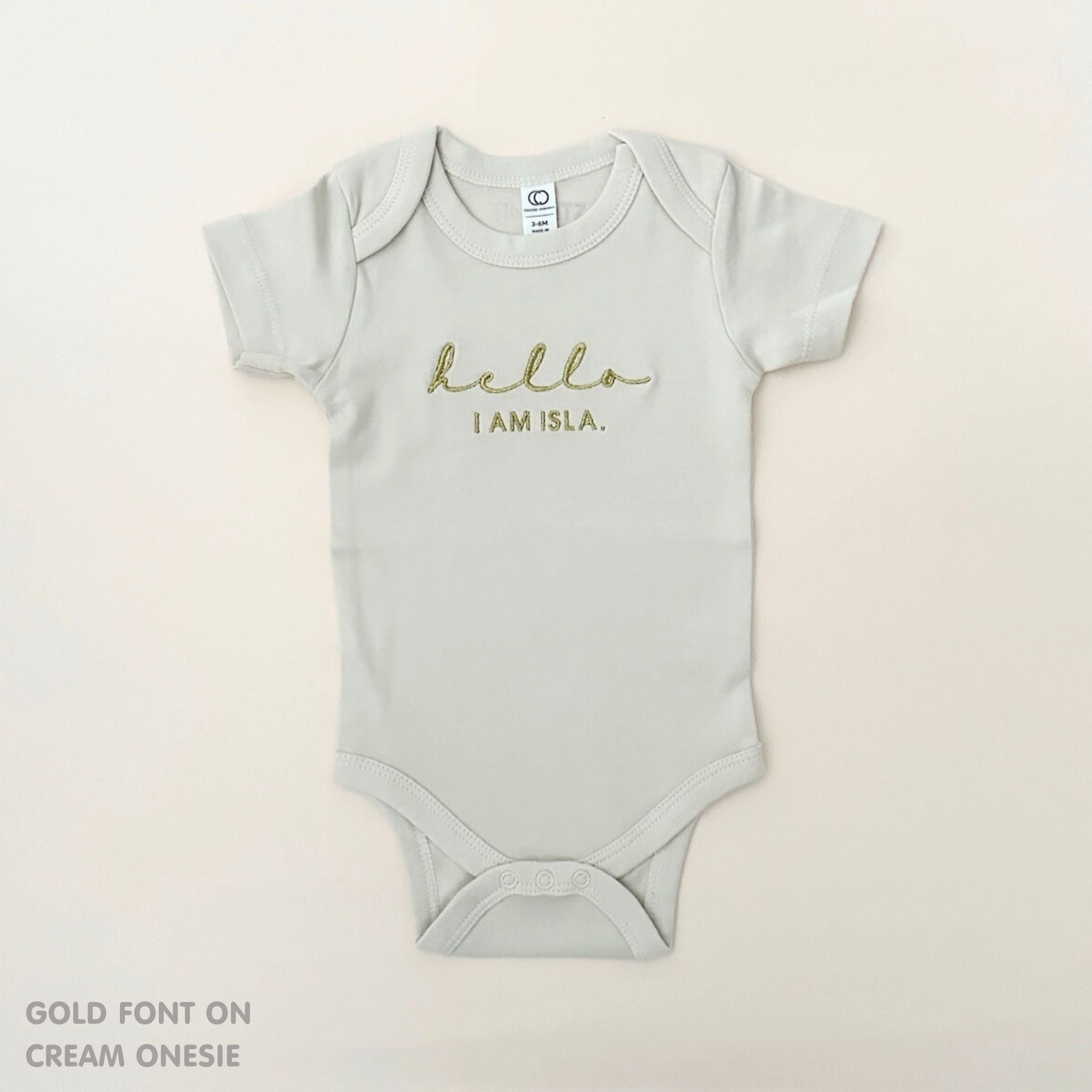 Organic cotton cream onesie for babies with embroidered name, personalized baby shower gift keepsake from TinyBitz.