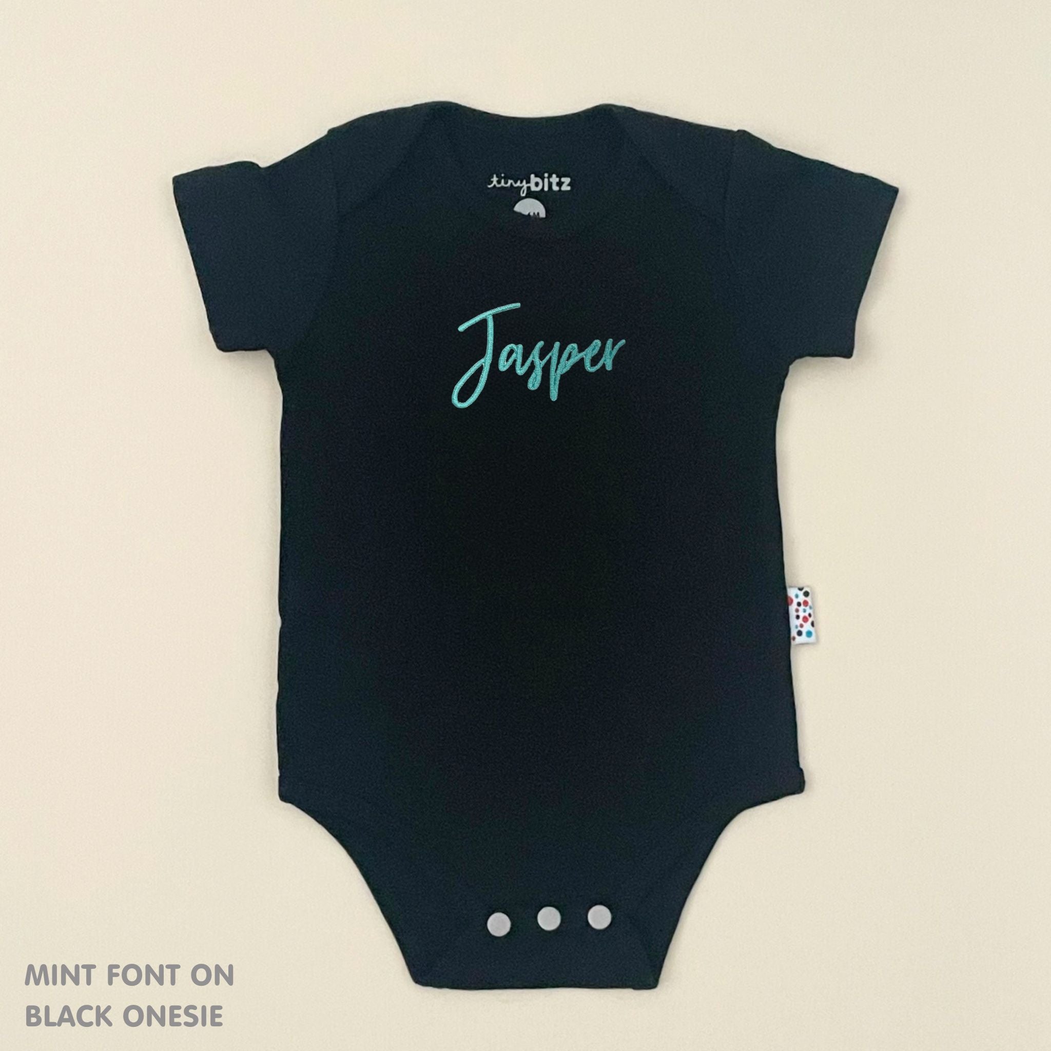 Organic cotton black onesie for babies with embroidered name, personalized baby shower gift keepsake from TinyBitz.