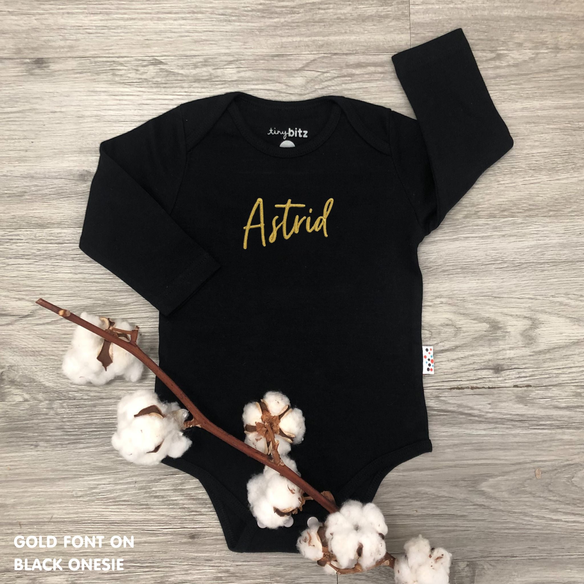 Custom name onesie in black, personalised baby clothing made with soft breathable fabric by TinyBitz.