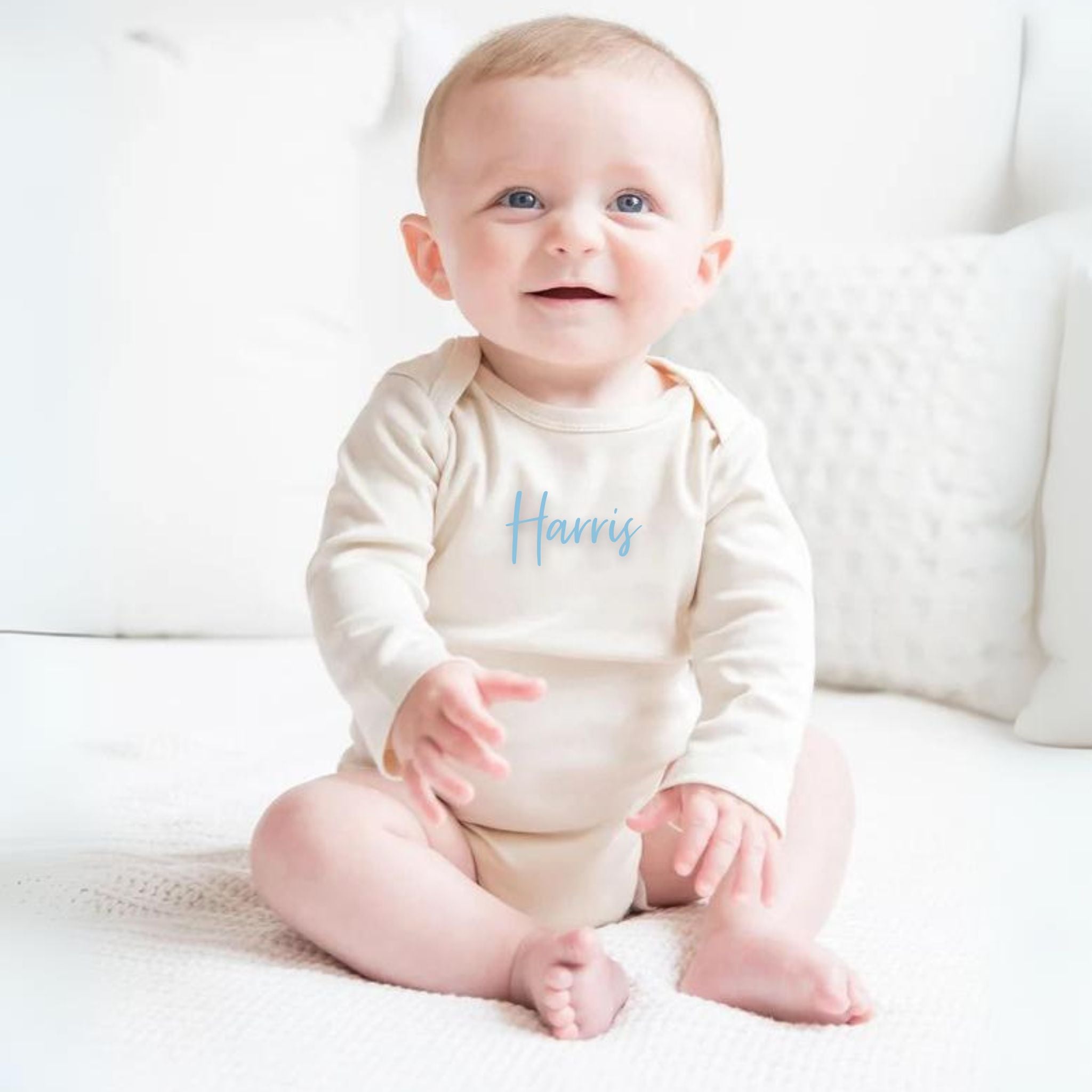 TinyBitz Custom baby onesie in cream with name embroidery, unique outfit for baby’s birth announcement or first photoshoot.