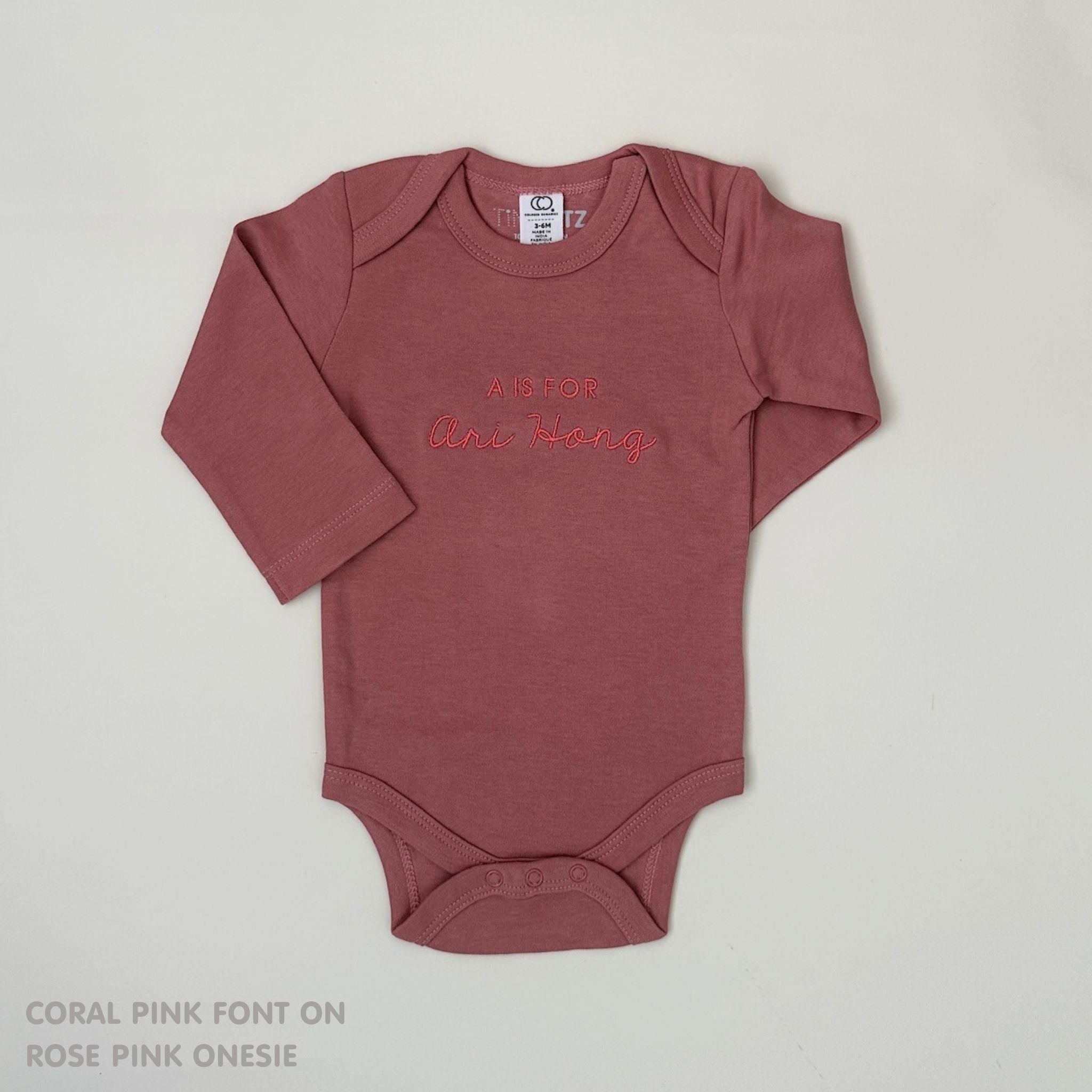 Organic cotton rose pink onesie for babies with embroidered name, personalized baby shower gift keepsake from TinyBitz.