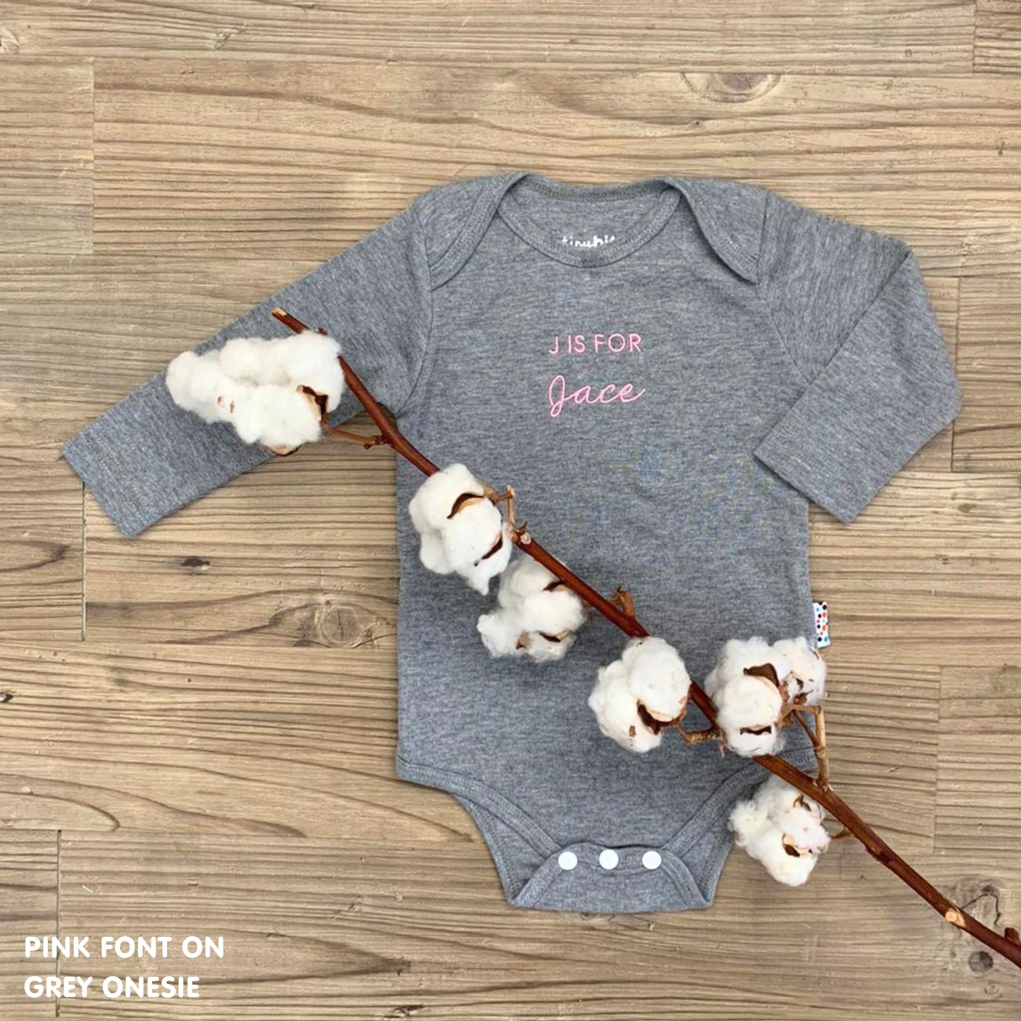 TinyBitz Personalised baby onesie with embroidered name in soft grey cotton, perfect for birth announcements and newborn photos.