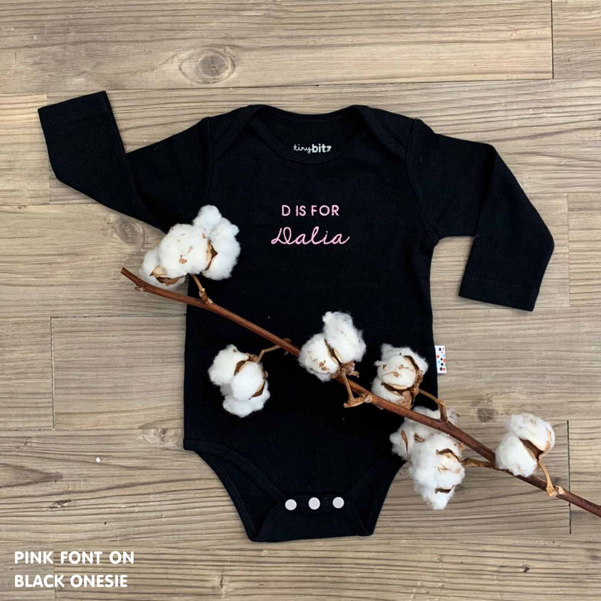 TinyBitz Custom baby onesie in black with name embroidery, unique outfit for baby’s birth announcement or first photoshoot.