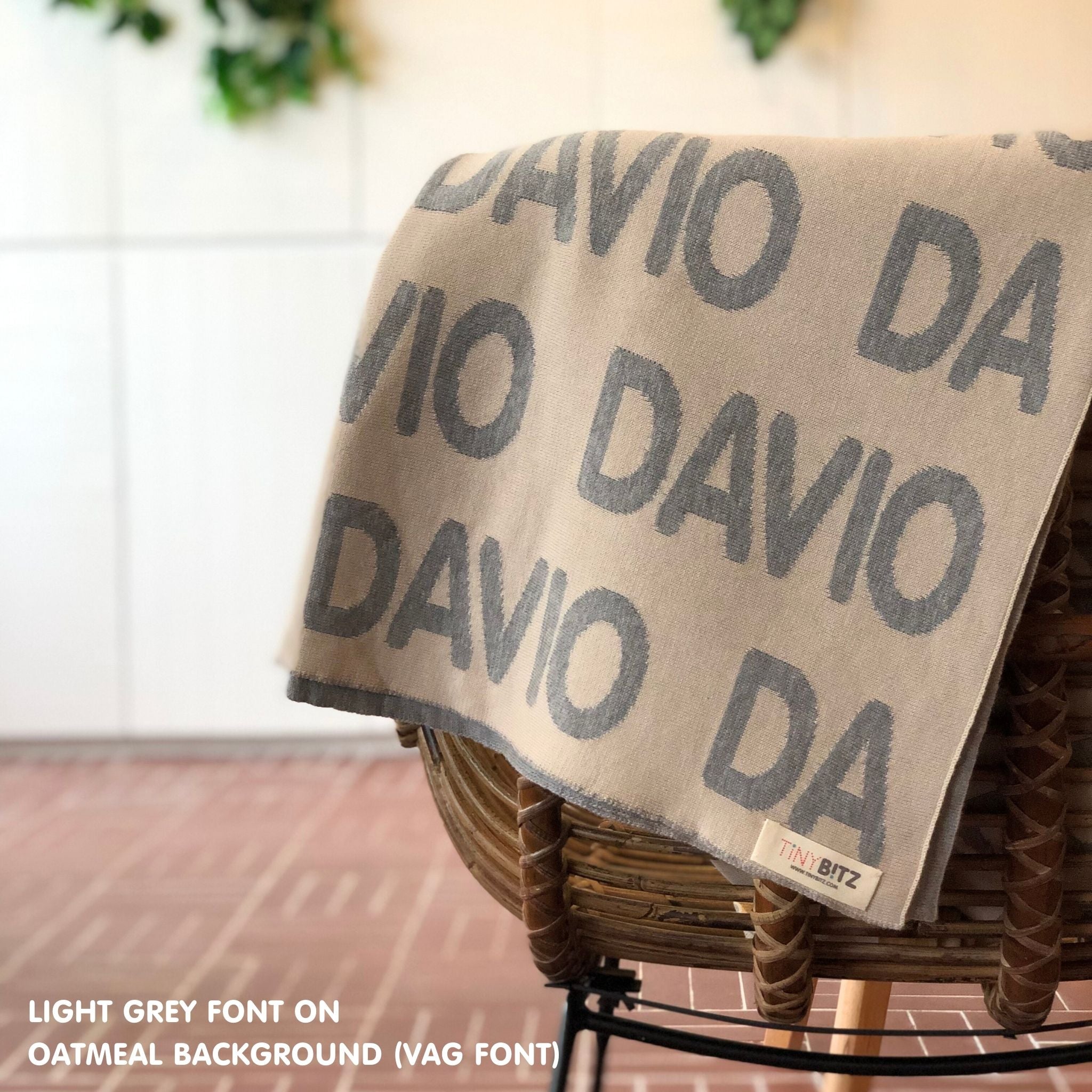 Personalised pet blanket in oatmeal and light grey knitted cotton, custom dog blanket by TinyBitz, styled on modern wooden dog bed.