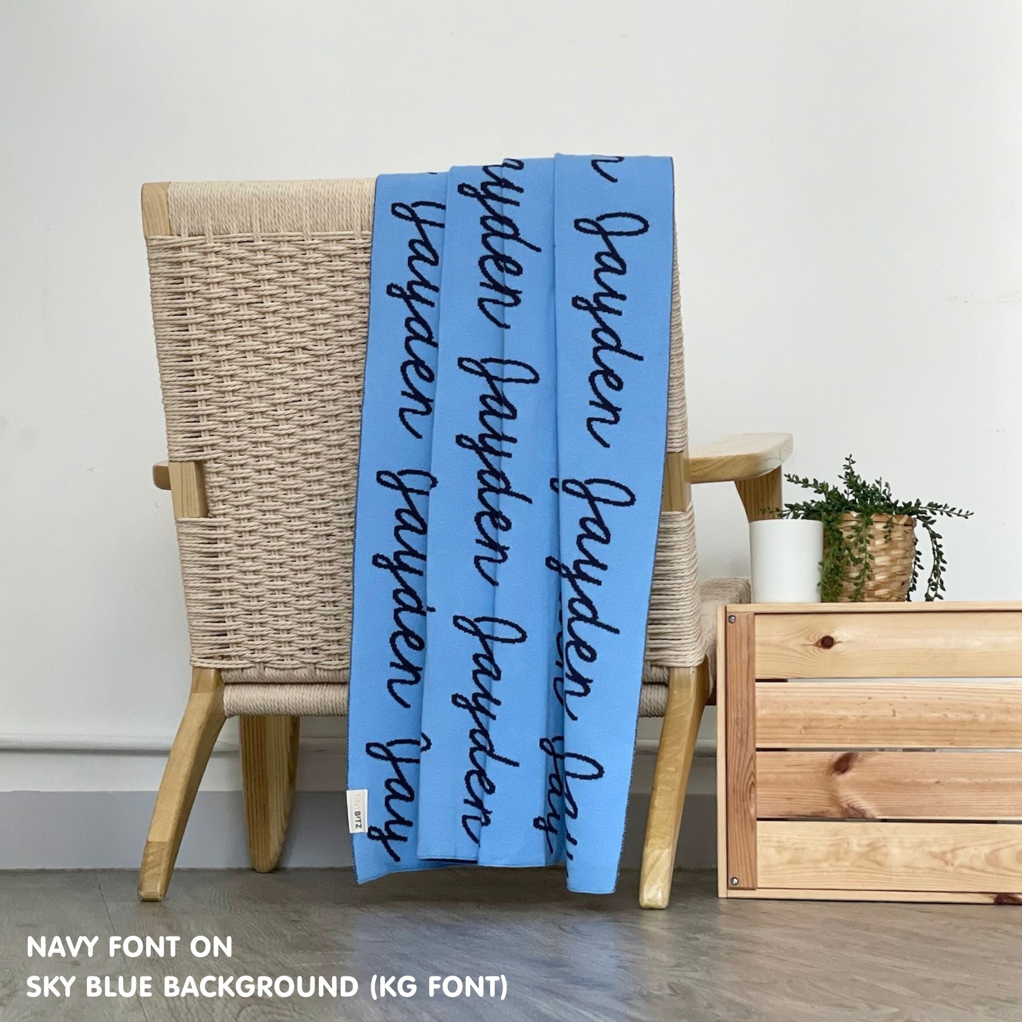 Personalised pet blanket for dogs in sky blue and navy, custom knitted dog blanket by TinyBitz, cozy gift for small dogs.