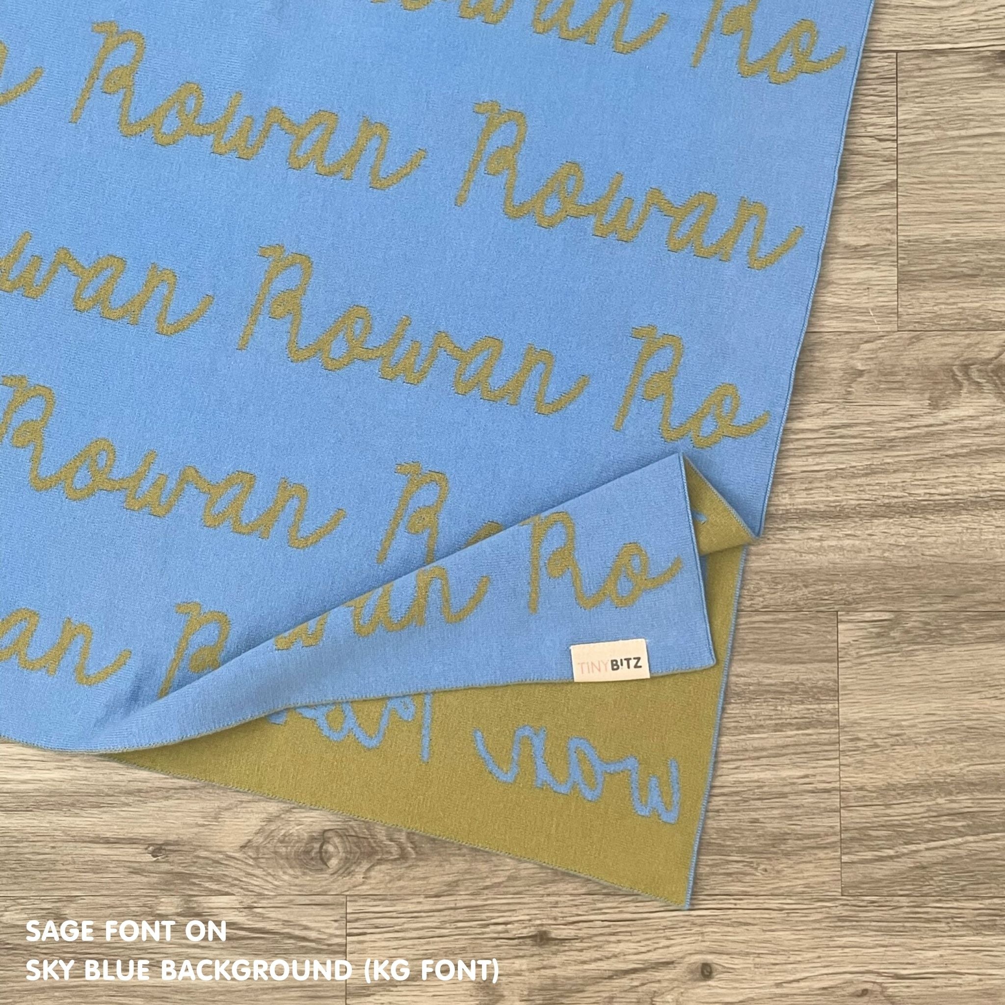 Personalised pet blanket for in sky blue and sage knitted cotton, custom dog blanket by TinyBitz, styled on modern wooden dog bed.