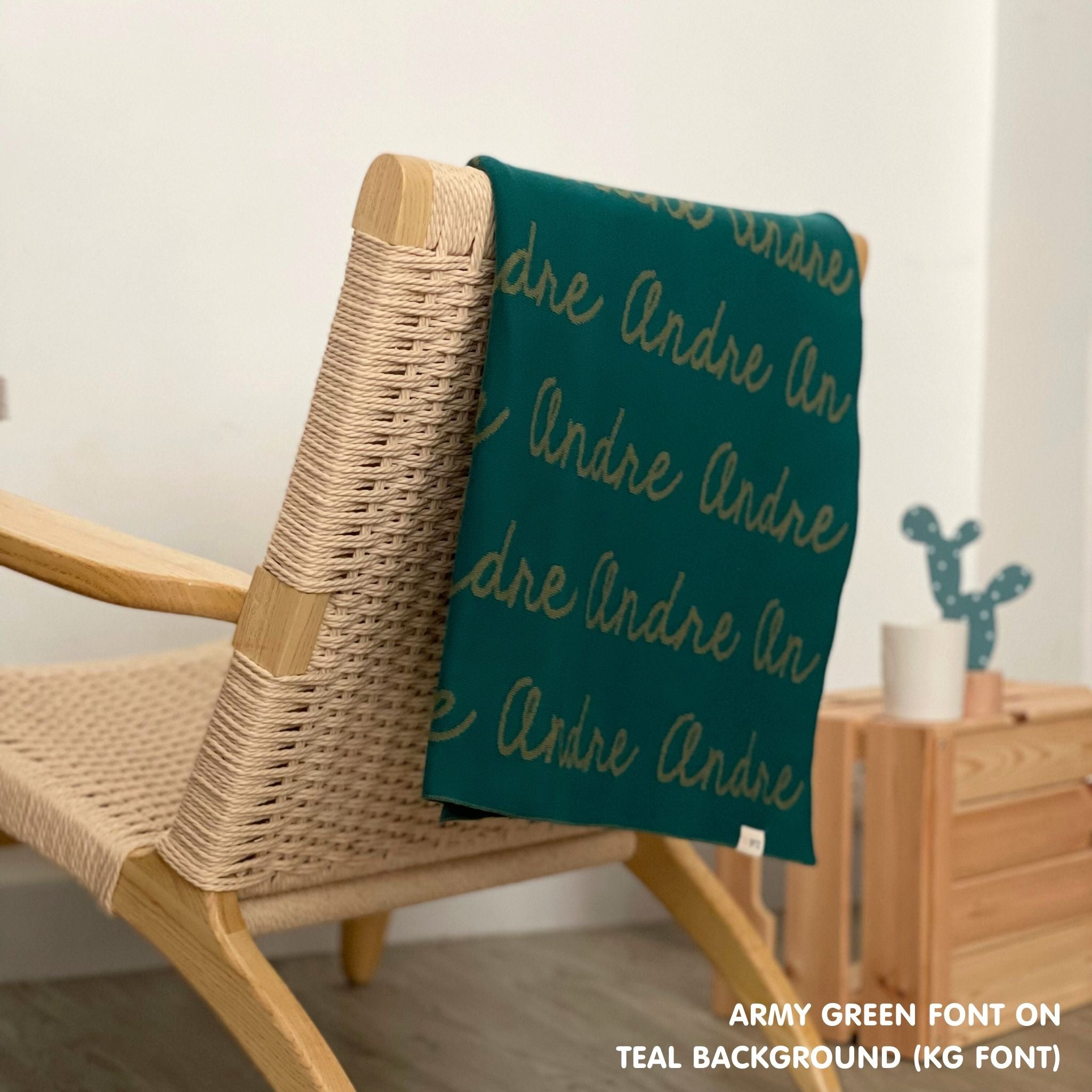 Personalised pet blanket in teal and army green knitted cotton, custom dog blanket by TinyBitz, styled on modern wooden dog bed.