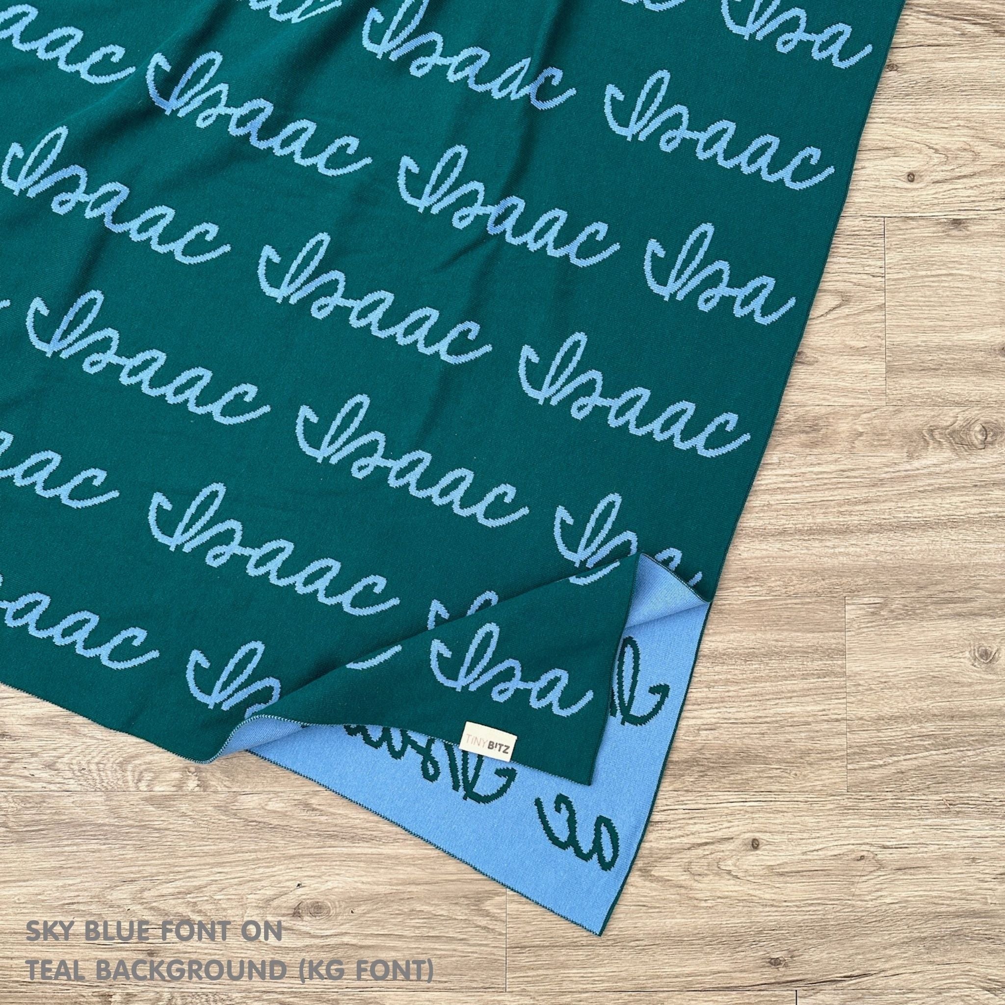 Personalised pet blanket in teal and sky blue knitted cotton, custom knitted dog blanket by TinyBitz, perfect gift for dog lovers.