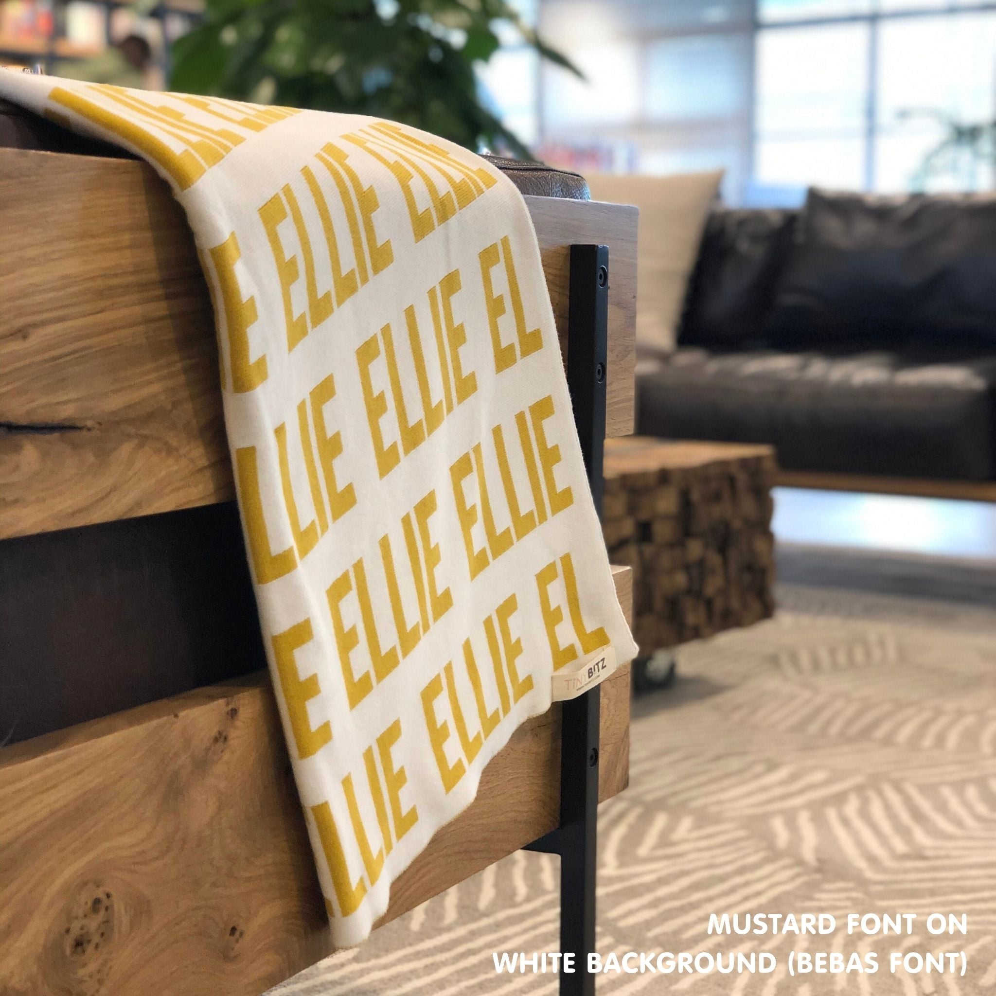 Personalised pet blanket in white and mustard knitted cotton, custom dog blanket by TinyBitz, styled on modern wooden dog bed.