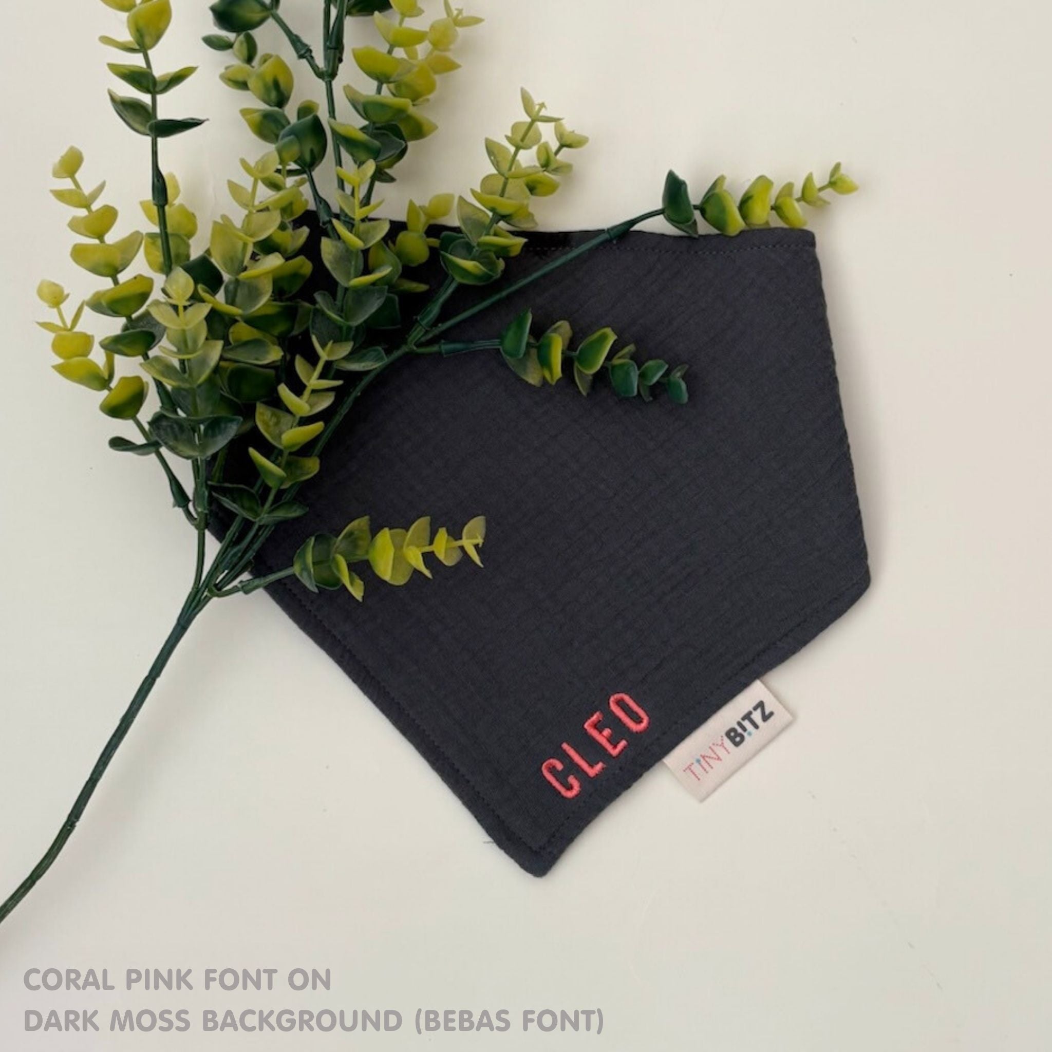Custom baby bib in dark moss with embroidered name, personalised baby gift made from breathable muslin by TinyBitz.