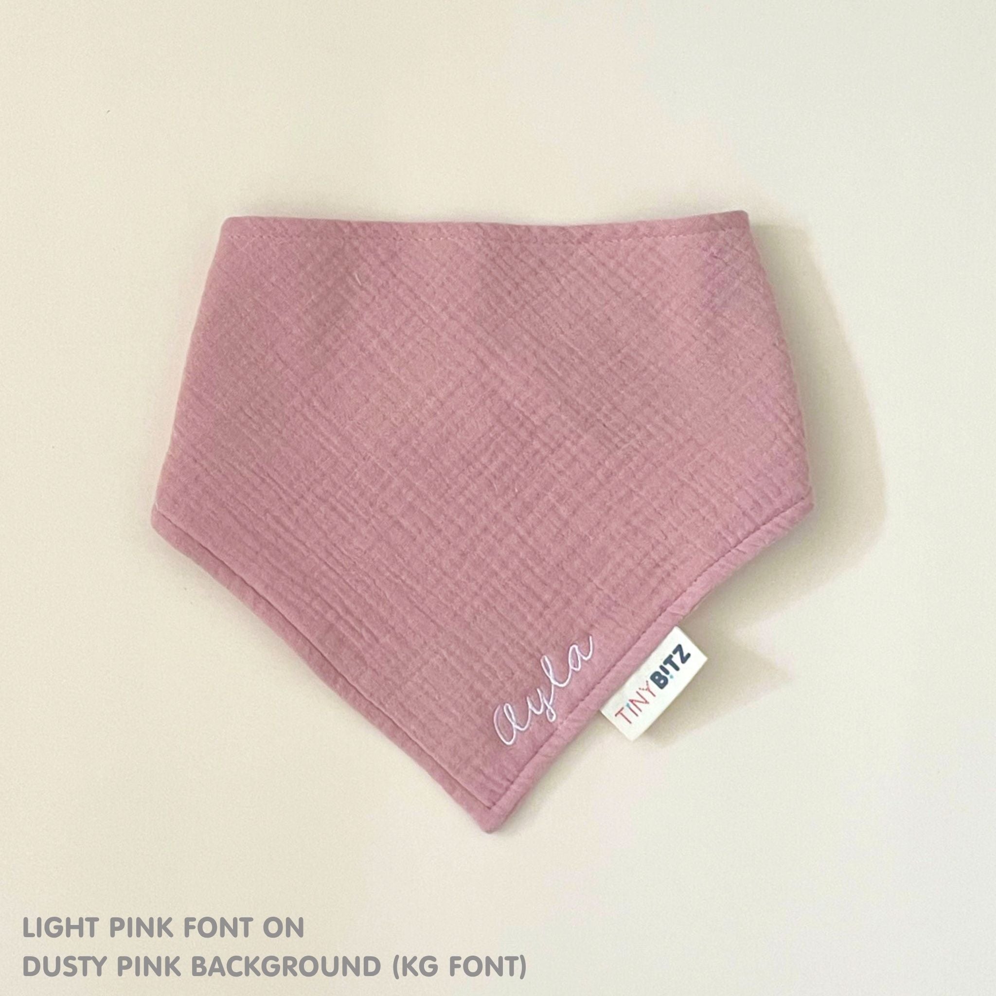 Organic personalised bib for babies in dusty pink, featuring baby name in script font, unique baby gift idea by TinyBitz.