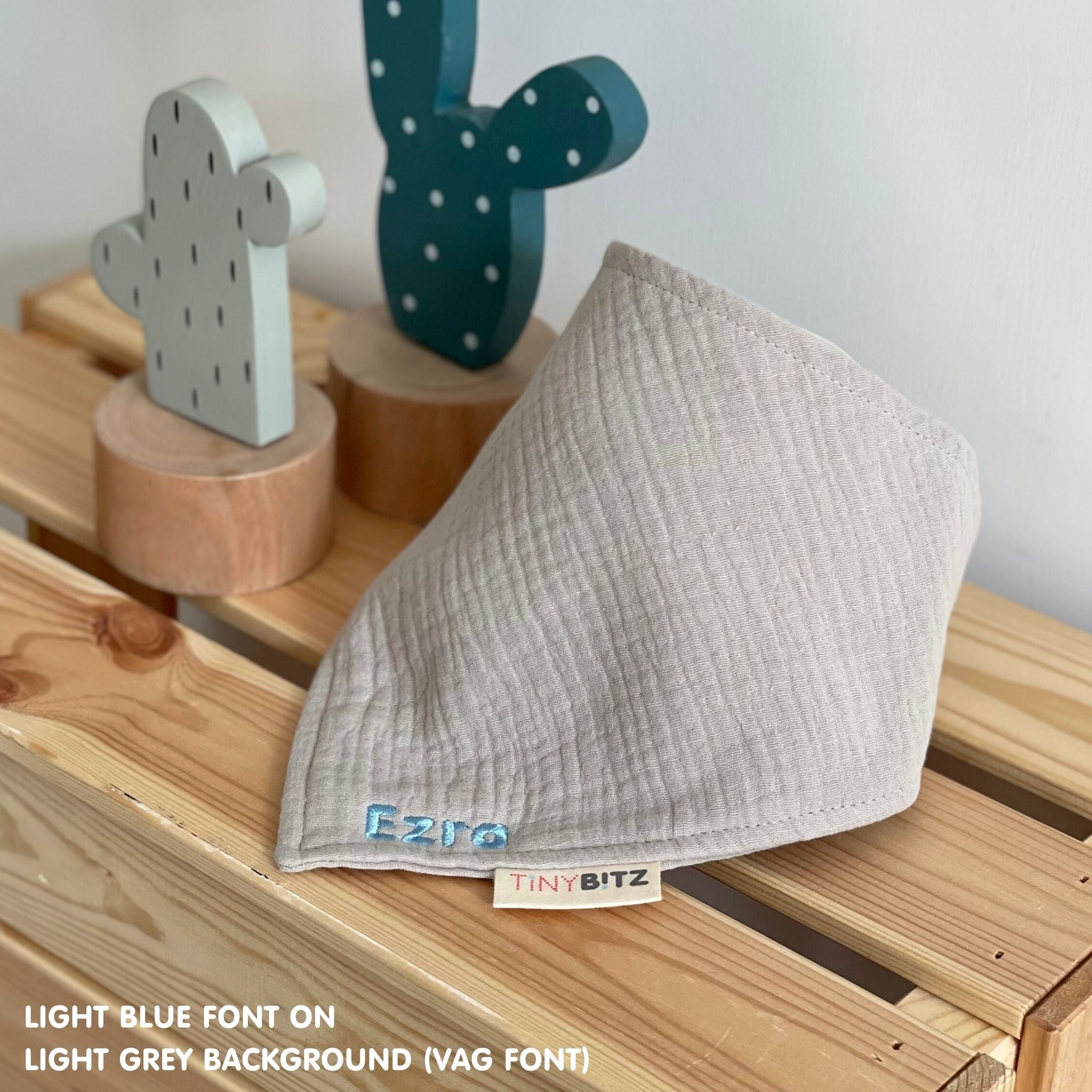 Neutral-toned personalised baby bib with minimalist name embroidery, custom made to order newborn gift by TinyBitz.