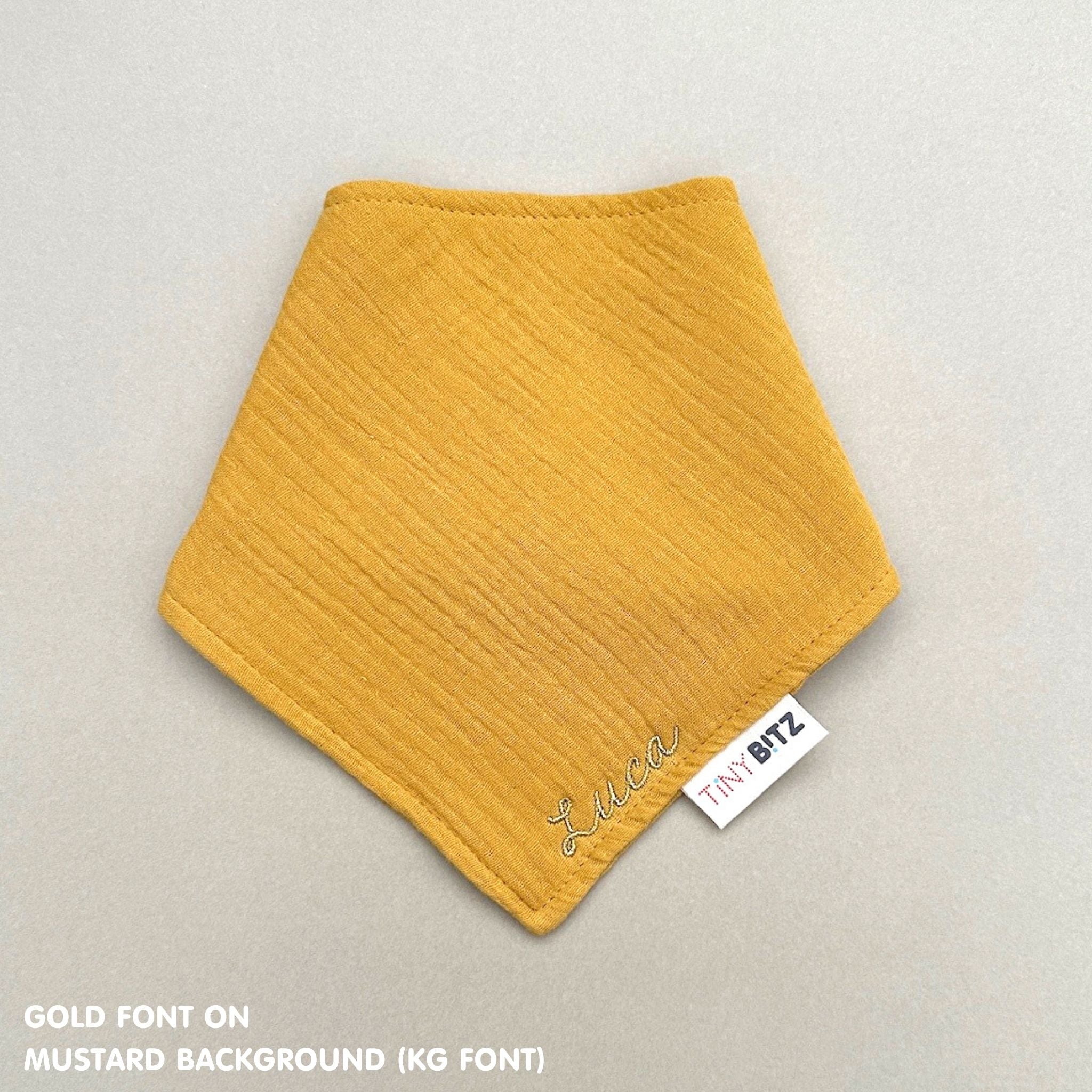 Custom baby bib in mustard with embroidered name, personalised baby gift made from breathable muslin by TinyBitz.