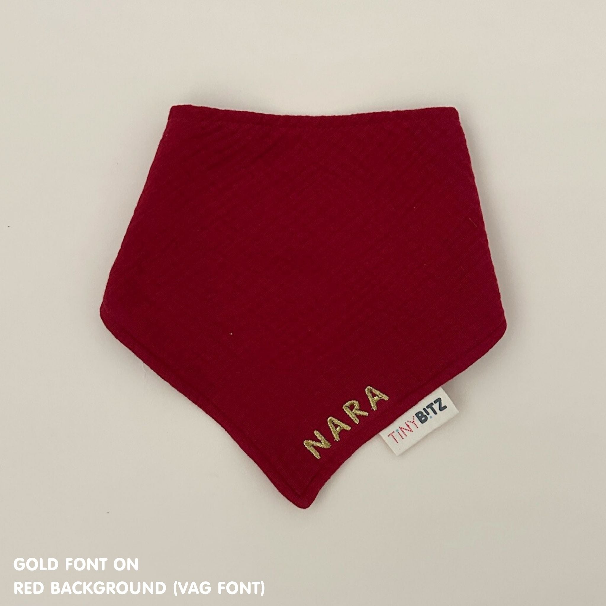 Organic cotton baby bib with name stitched on red fabric, personalised baby gifts by TinyBitz.