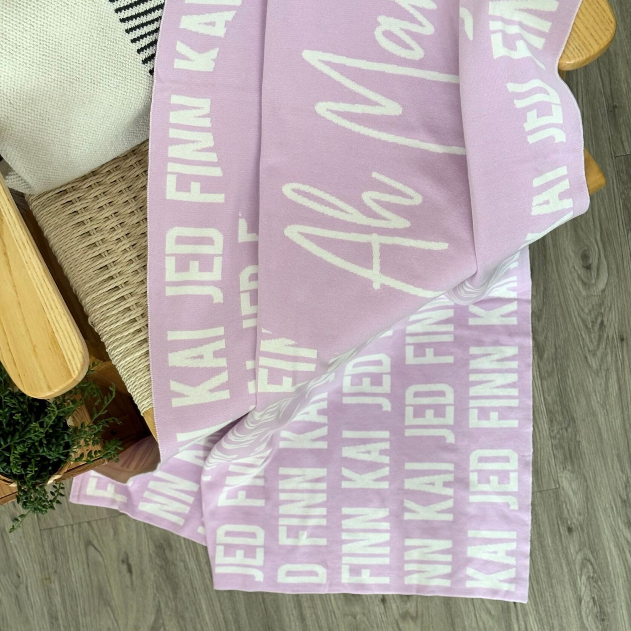 Custom blanket with grandma's name knitted in the centre, surrounded by their kids and grandkid's names, made by TinyBitz.