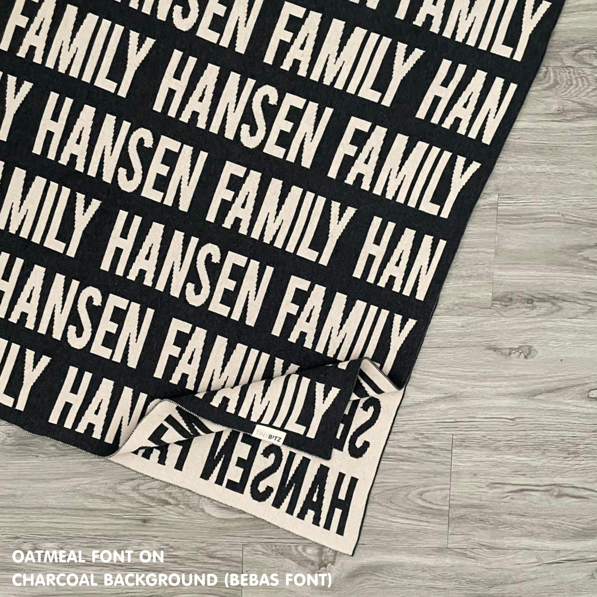 Personalised family blanket knitted in charcoal and oatmeal, custom made by TinyBitz.