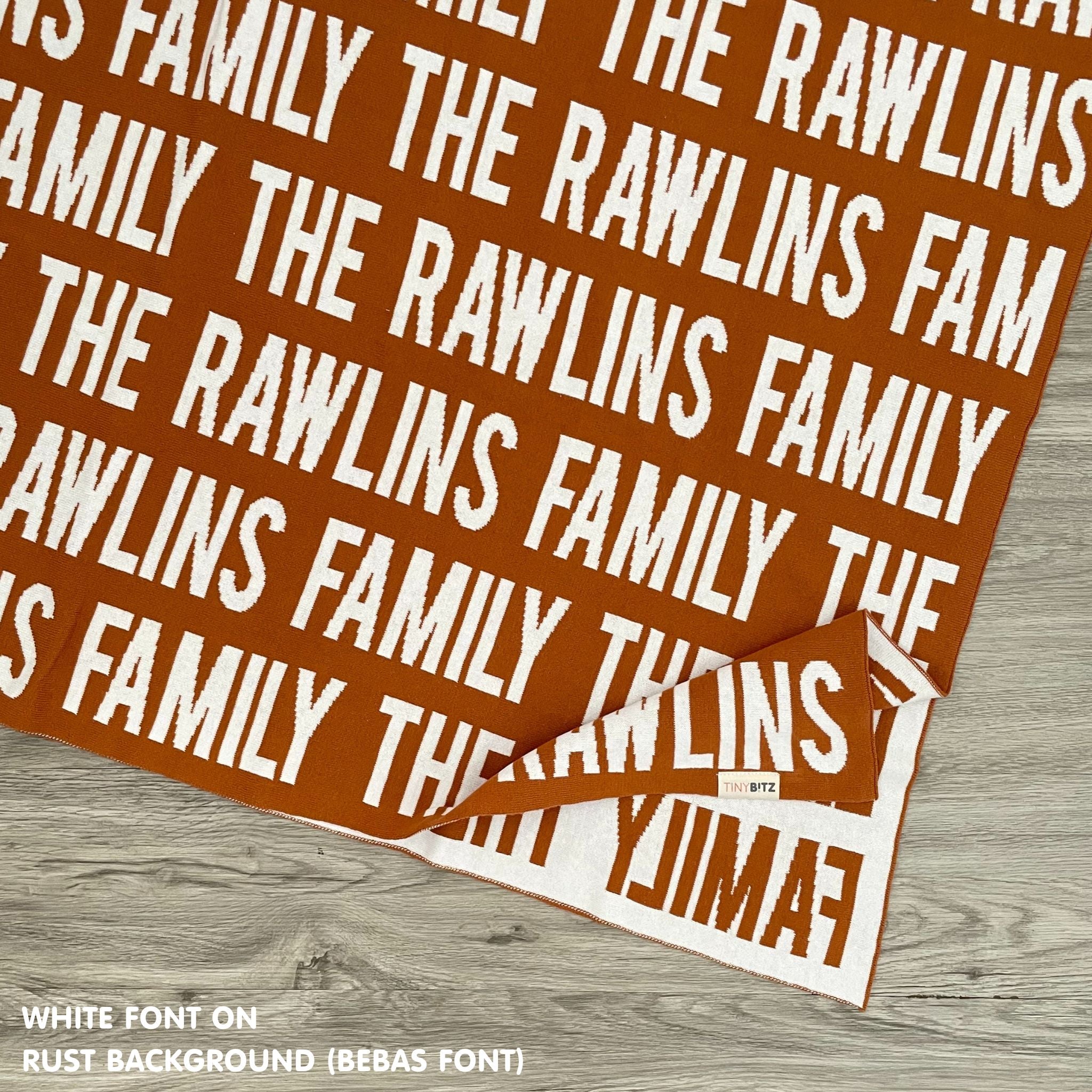 Personalised family blanket knitted in rust and white, custom made by TinyBitz.