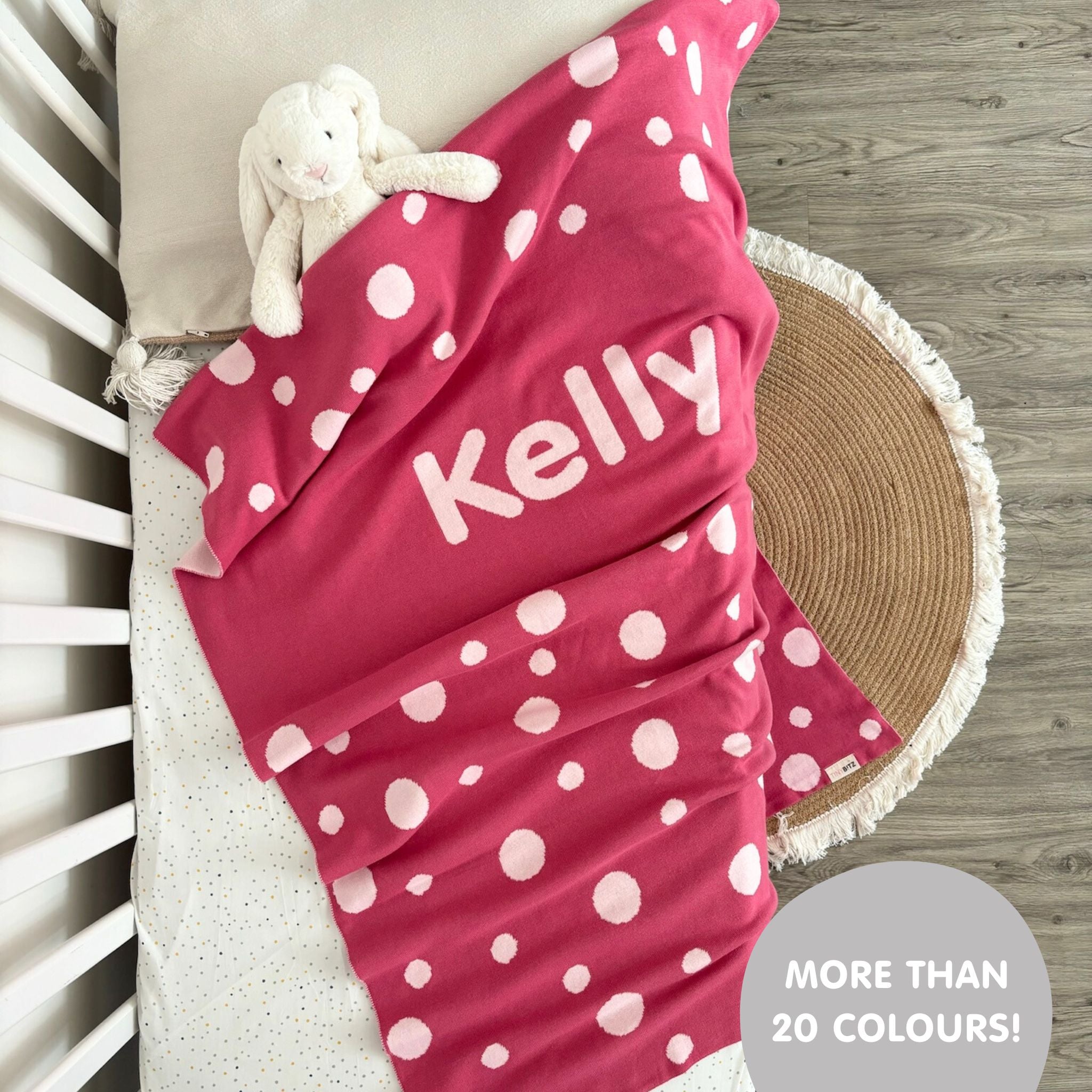 Knitted baby blanket in rose pink and light pink with a dot pattern, customised with baby's name, made by TinyBitz.