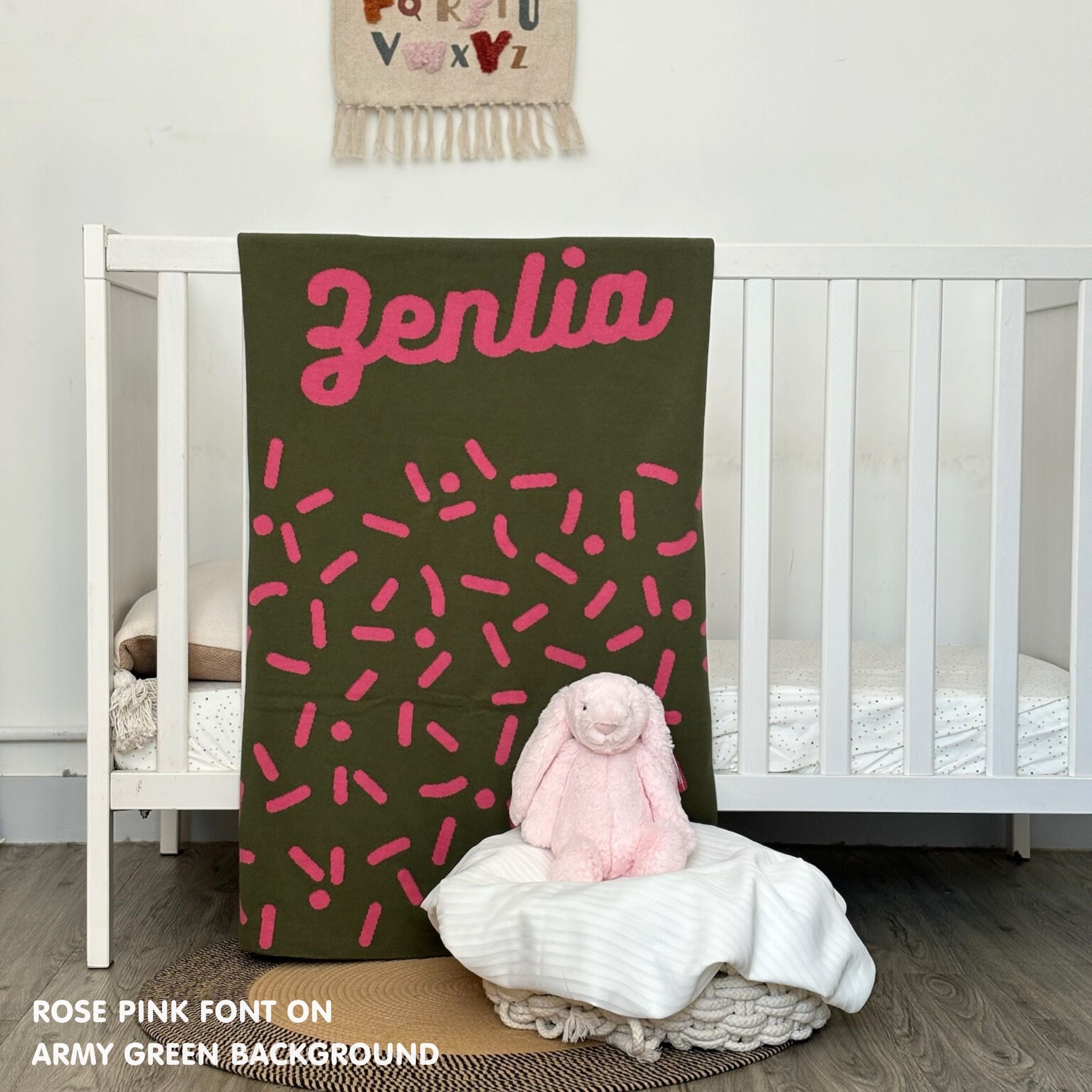 TinyBitz knitted name blanket in army green and rose pink with a confetti pattern, a lovely touch to decorate your baby's room!