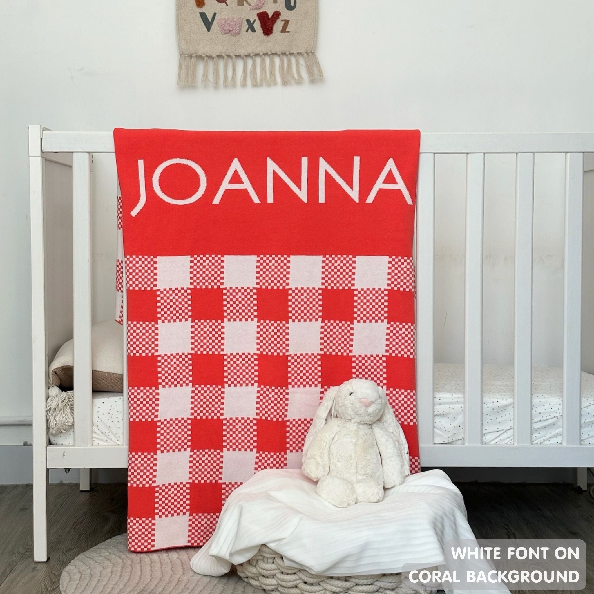 TinyBitz personalized name blanket in coral and white with a check pattern, perfect gift for newborn babies.