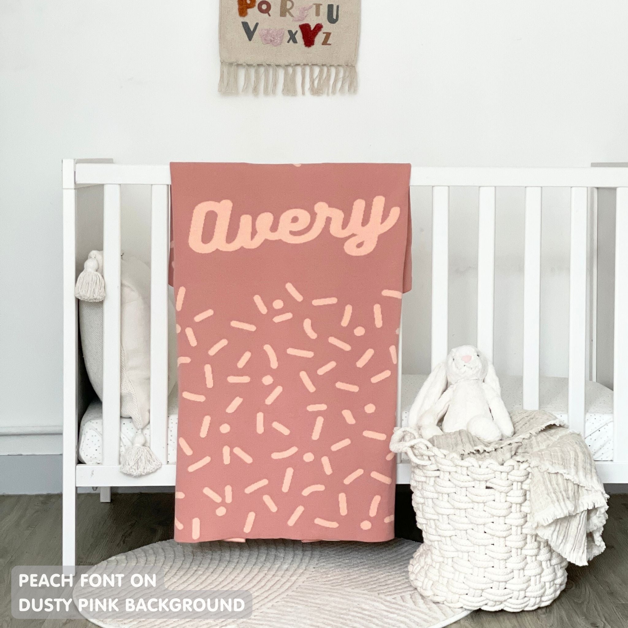 TinyBitz personalized baby name blanket, knitted in dusty pink and peach with a confetti pattern, perfect baby shower gift!