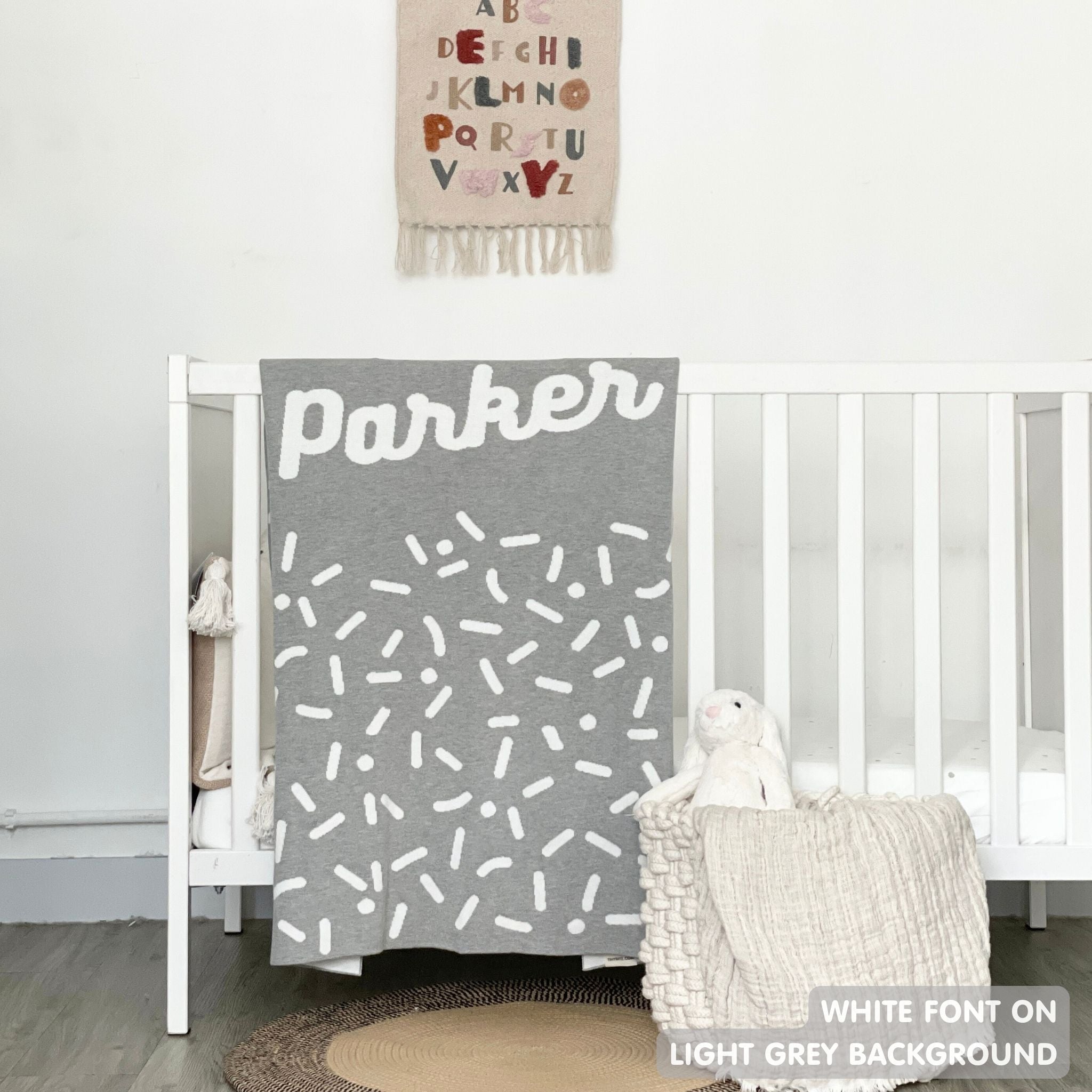 TinyBitz personalized name blanket in light grey and whitel with a confetti pattern, perfect gift for newborn babies and kids.