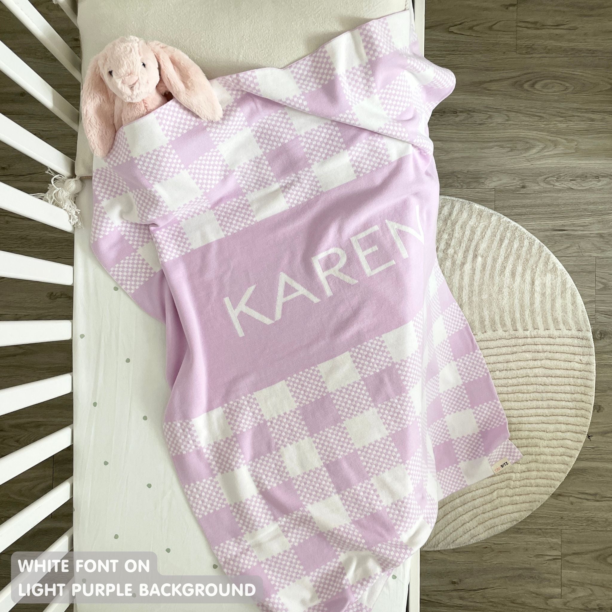 TinyBitz personalized baby name blanket, knitted in light purple and white with a check pattern, perfect baby shower gift!