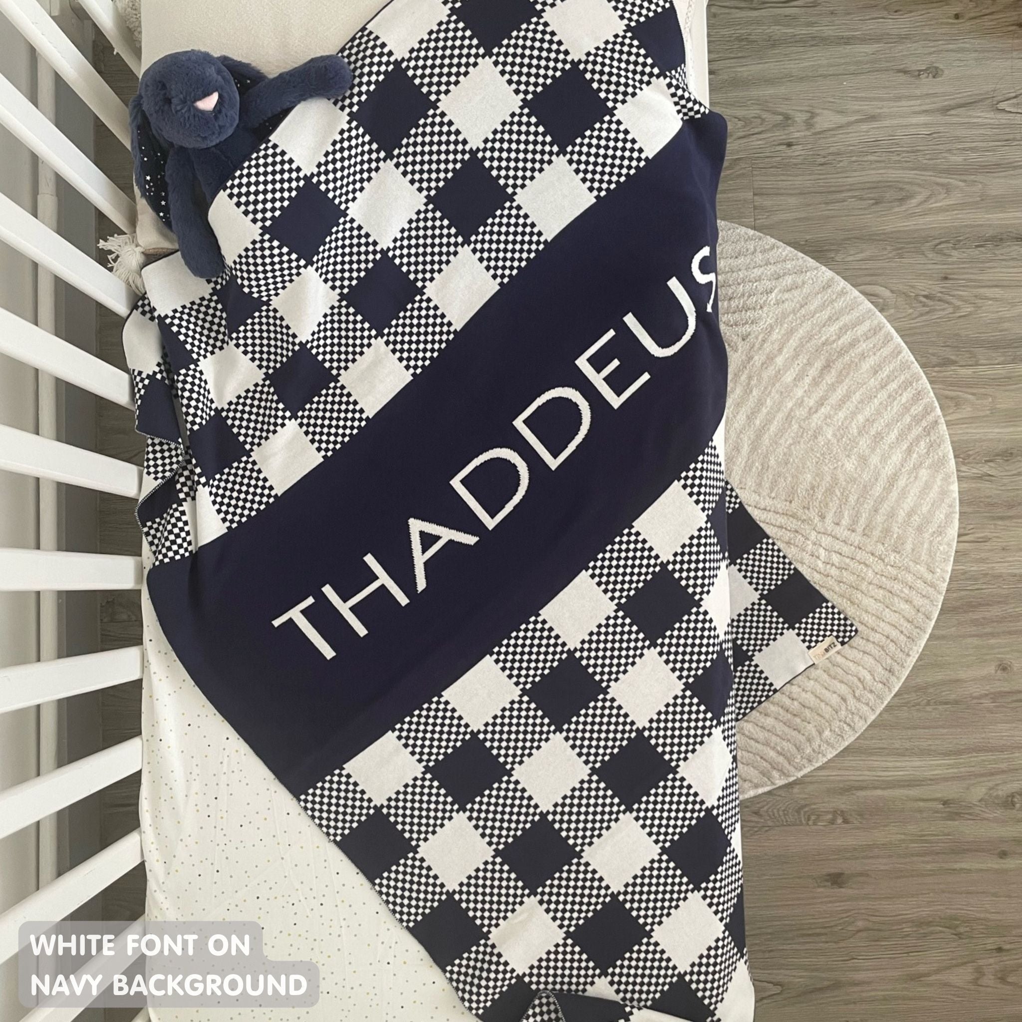 TinyBitz personalized name blanket in navy and white with a check pattern, perfect gift for newborn babies.