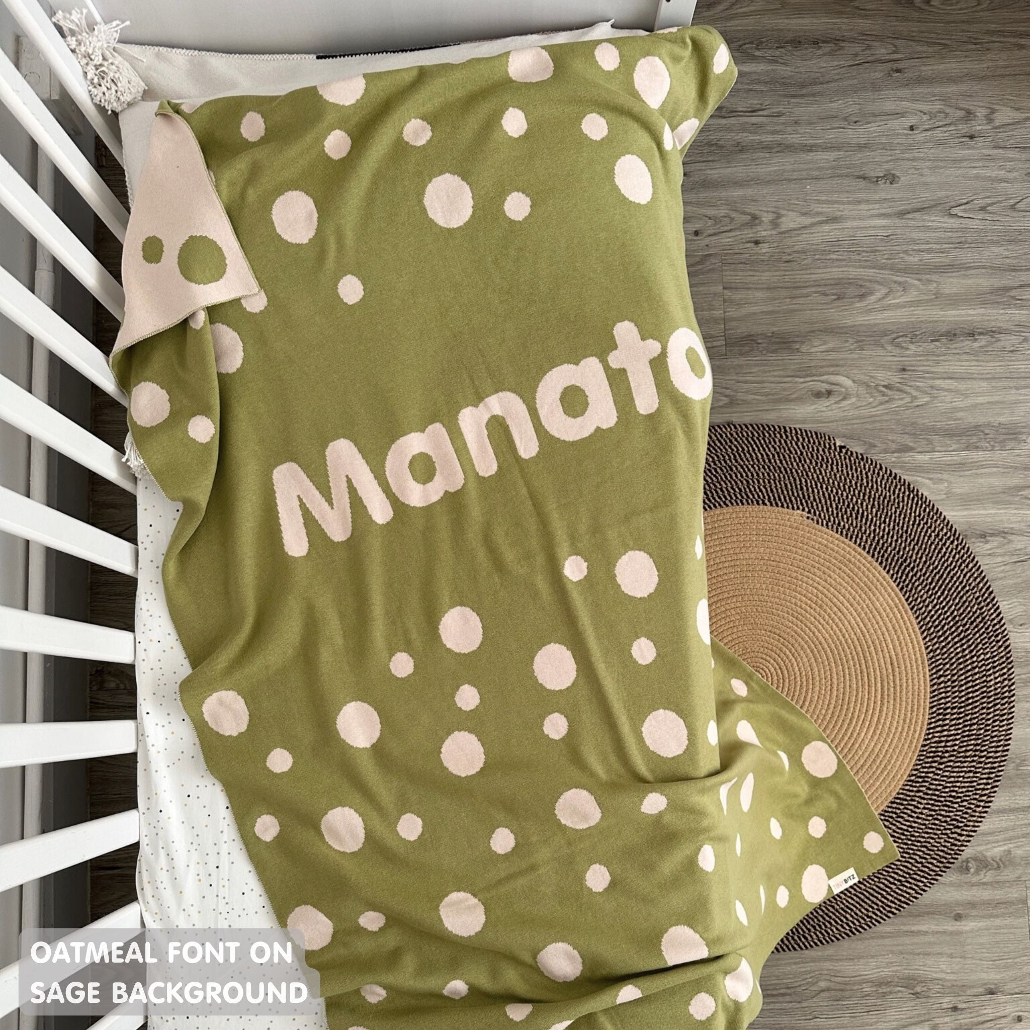 Knitted baby blanket in sage and oatmeal with a dot pattern, customised with baby's name, made by TinyBitz.