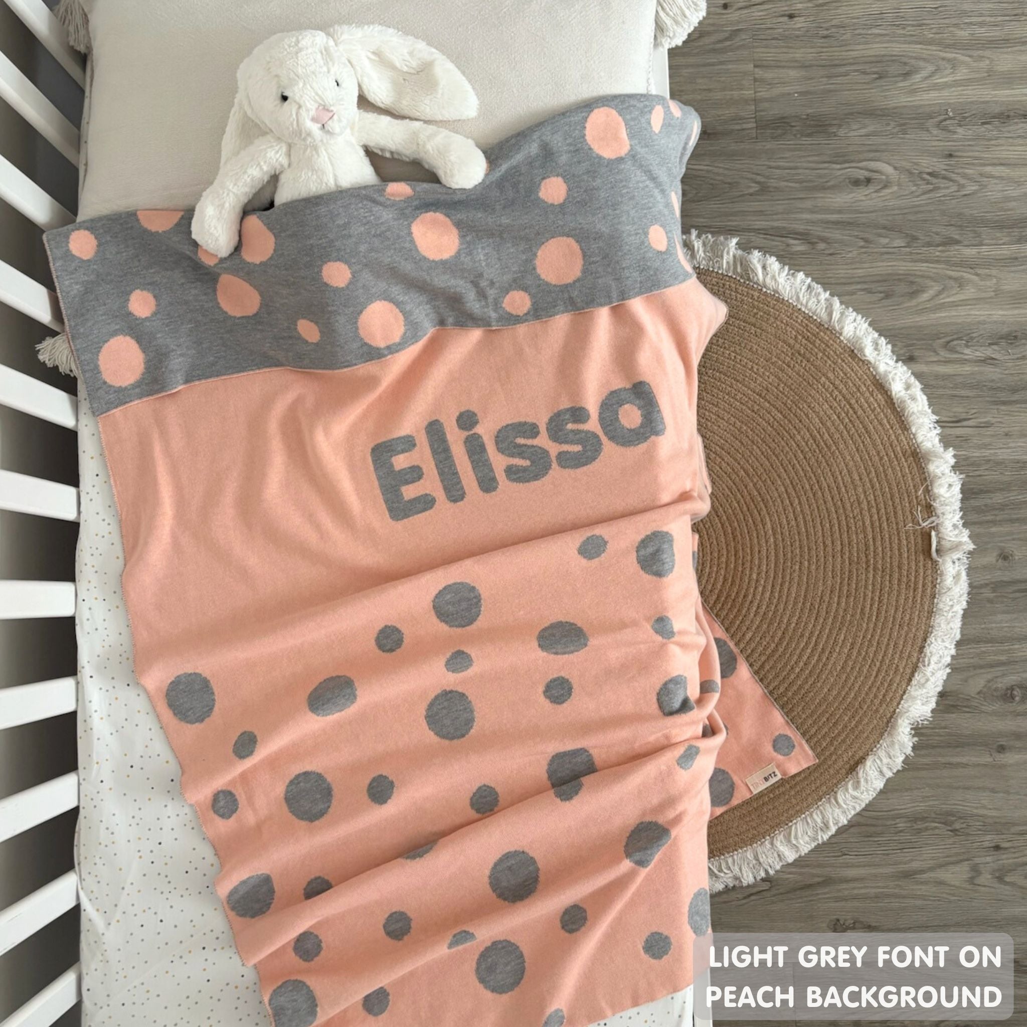 TinyBitz personalized baby name blanket, knitted in peach and light grey with a dot pattern, perfect baby shower gift!