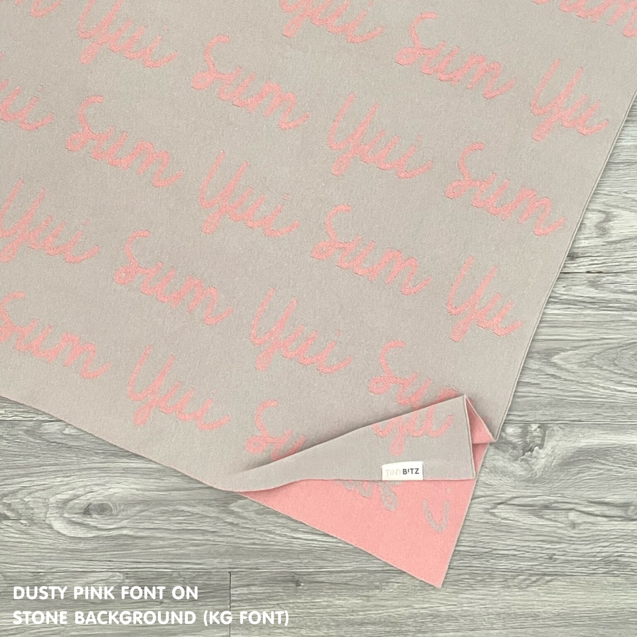 Knitted baby blanket in stone and dusty pink, customised with baby's name, made by TinyBitz.