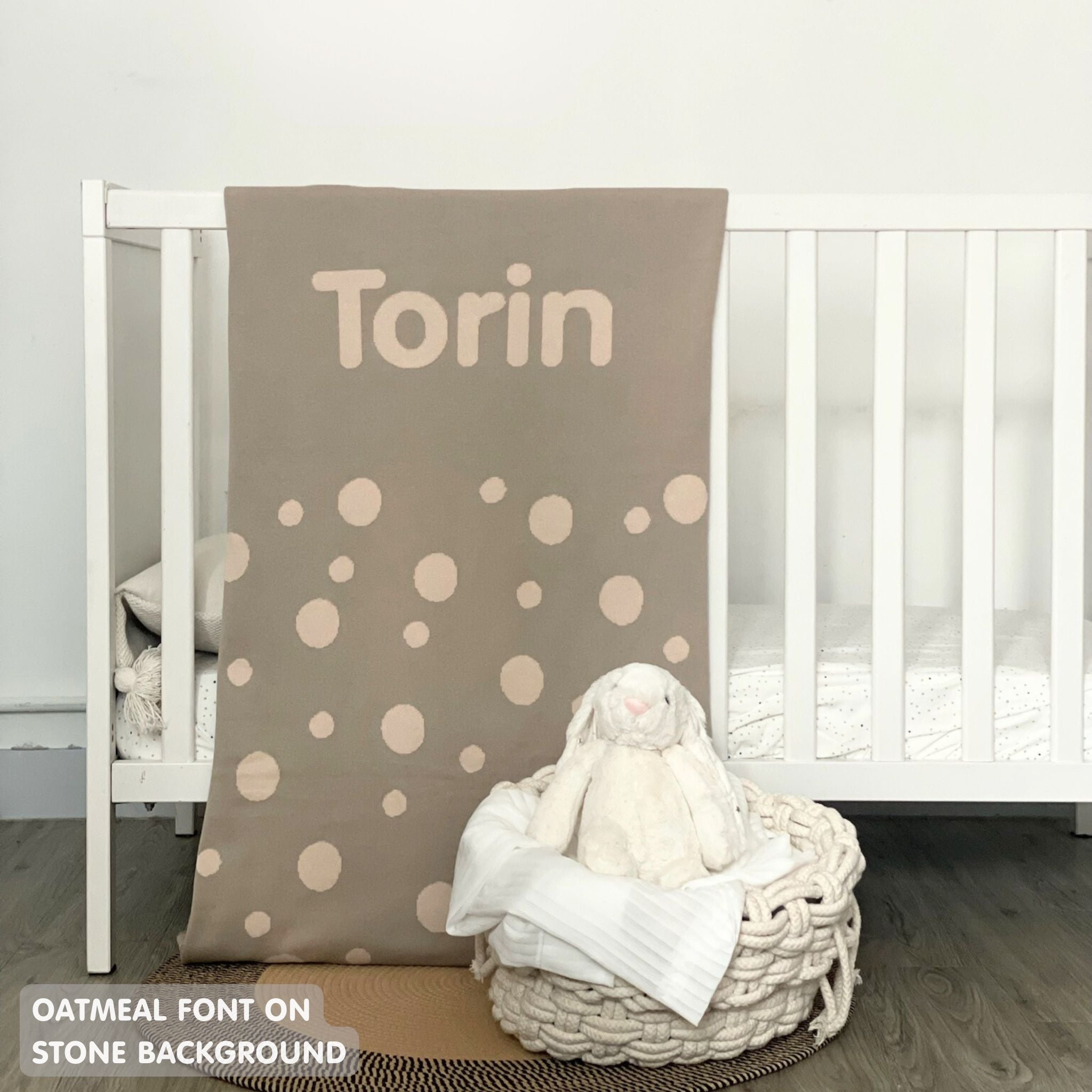 Knitted baby blanket in stone and oatmeal with a dot pattern, customised with baby's name, made by TinyBitz.