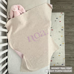 Knitted baby blanket in cream and light purple with a confetti pattern, customised with baby's name, made by TinyBitz.