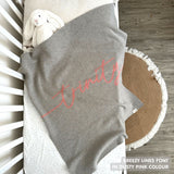 Knitted baby blanket in grey and dusty pink with a confetti pattern, customised with baby's name, made by TinyBitz.