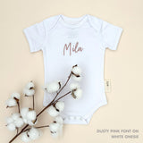 TinyBitz Personalised baby onesie with embroidered name in soft white cotton, perfect for birth announcements and newborn photos.