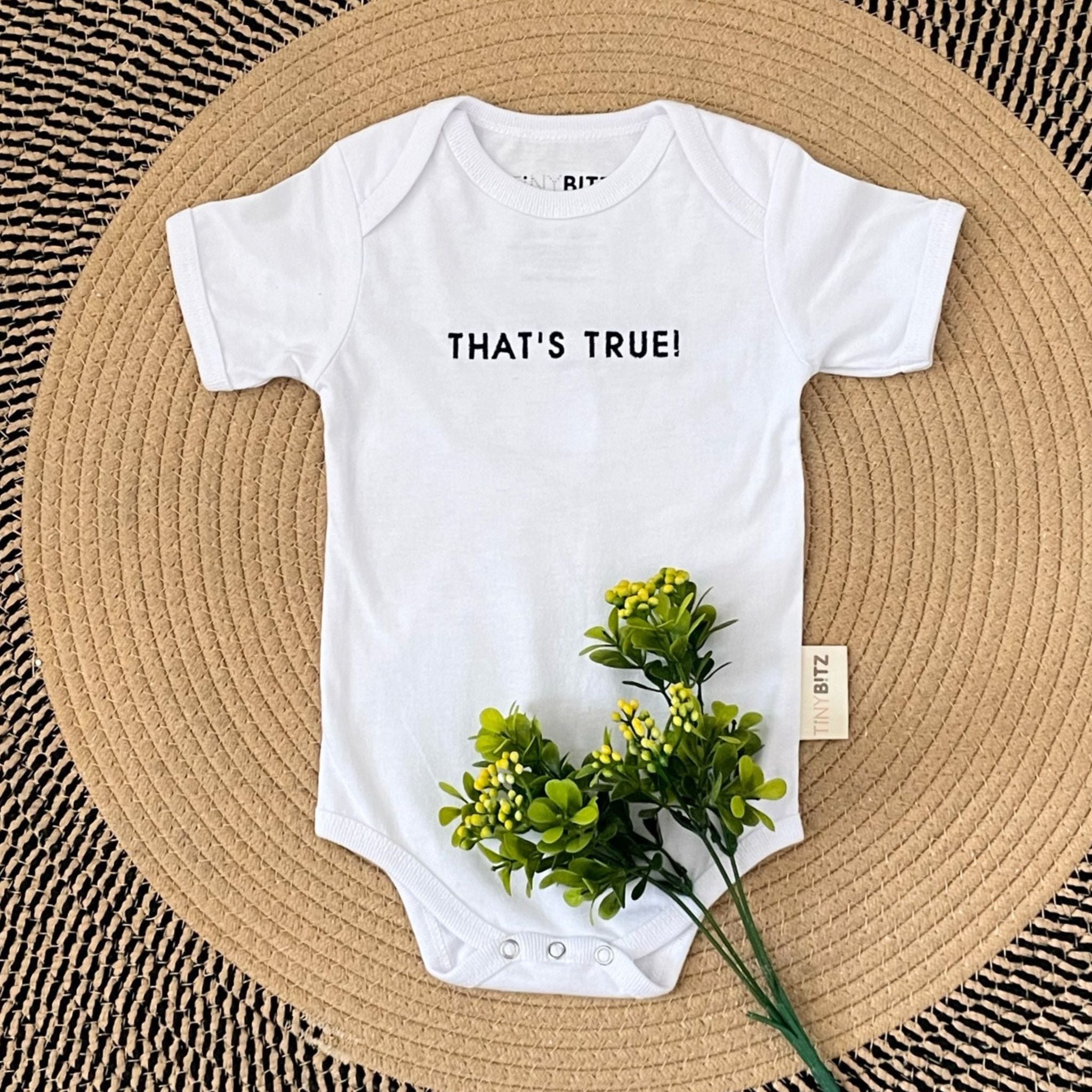 Personalised baby onesie with quote “That's True!” in white — custom newborn gift by TinyBitz