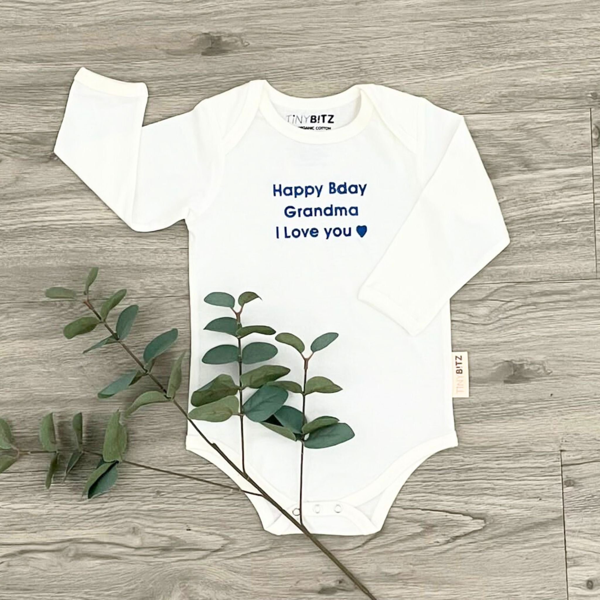 Organic cotton onesie for babies with quote “Happy Birthday Grandma I Love You” in white, personalized baby shower gift keepsake from TinyBitz.
