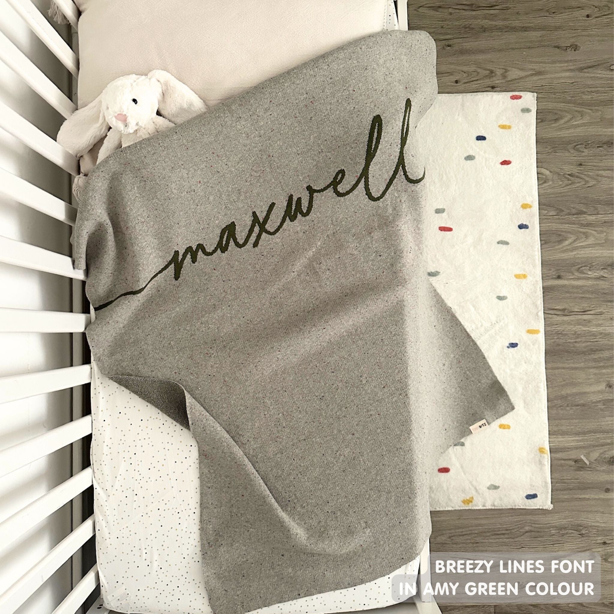 TinyBitz knitted name blanket in grey and army green with a confetti pattern, a lovely touch to decorate your baby's room!